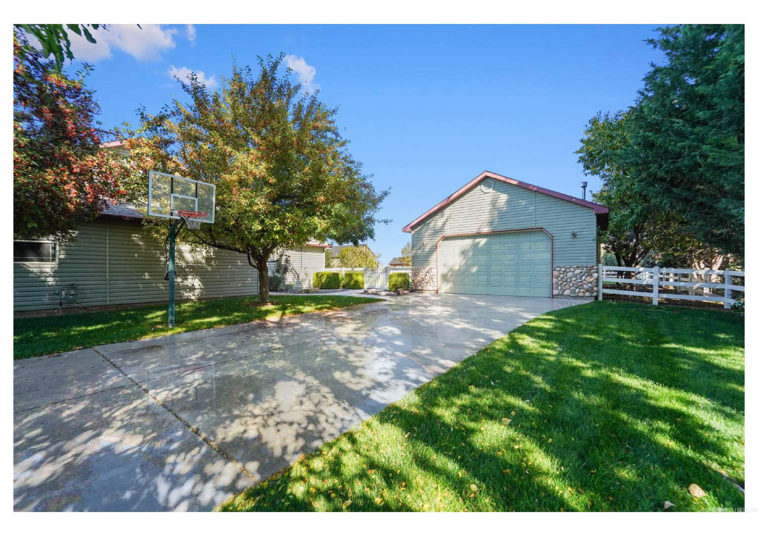 View of home's exterior with an outbuilding, stone siding, and a detached garage