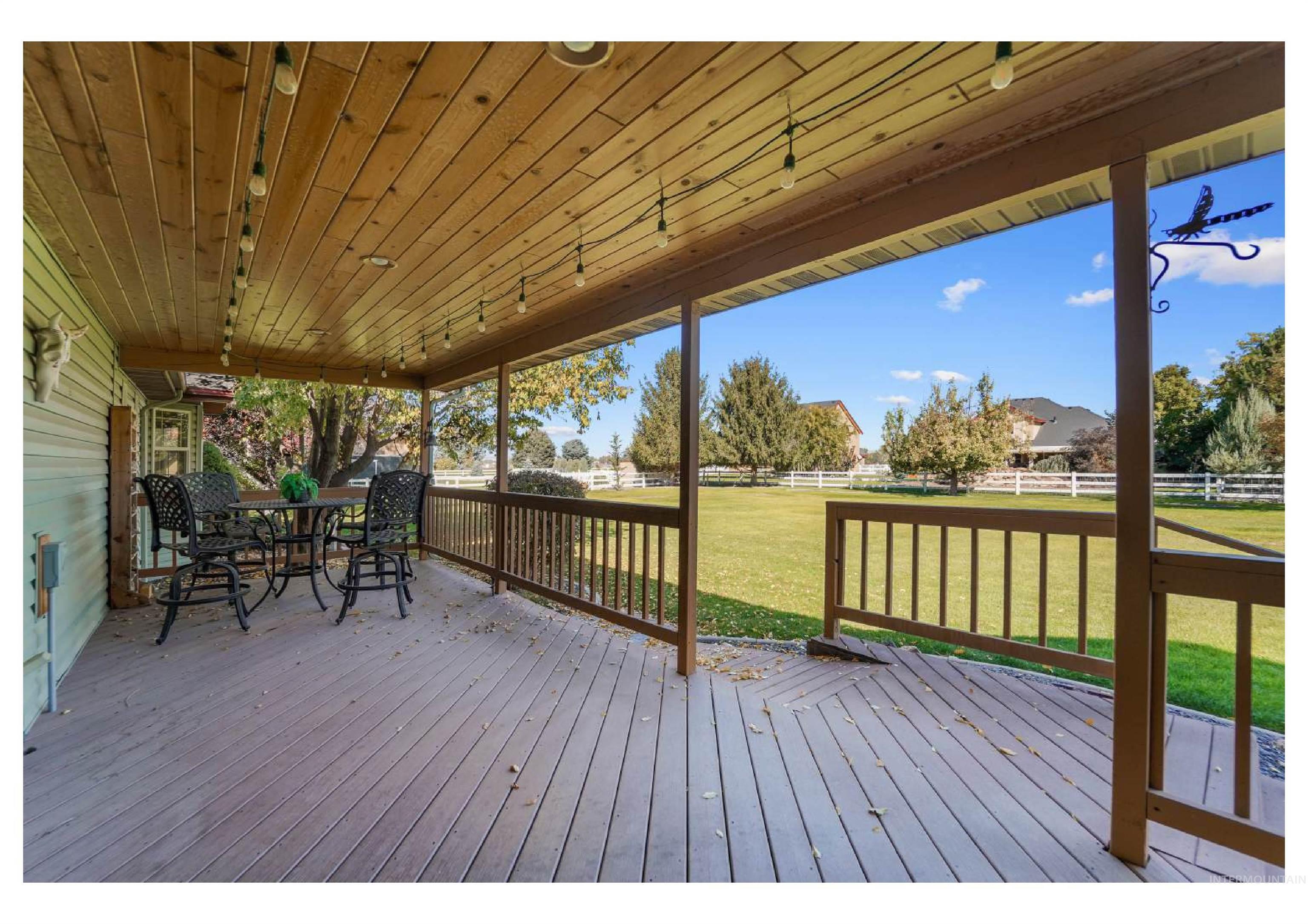 Wooden deck featuring outdoor dining area and a fenced backyard
