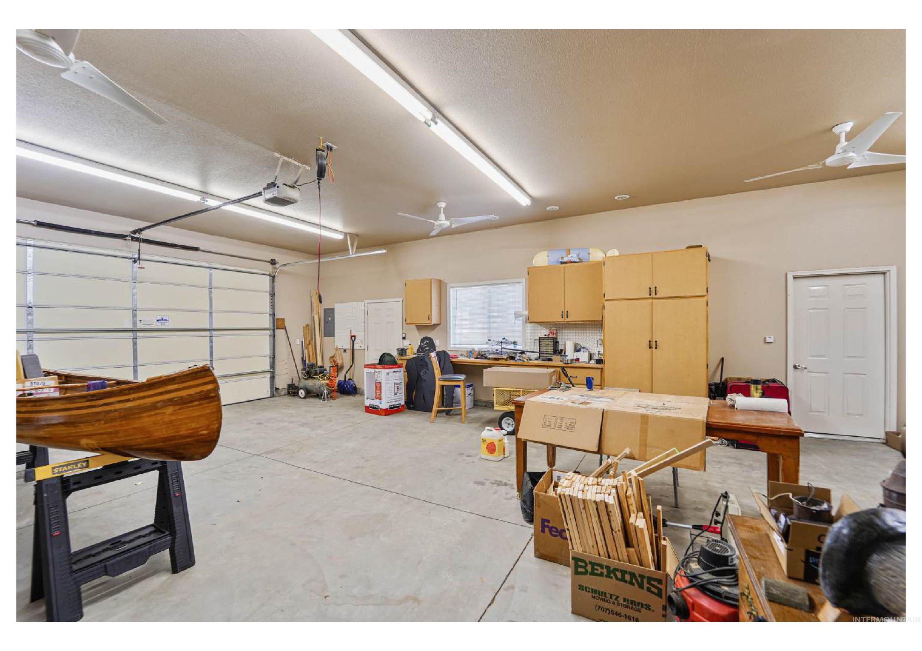 Garage featuring a ceiling fan and a garage door opener