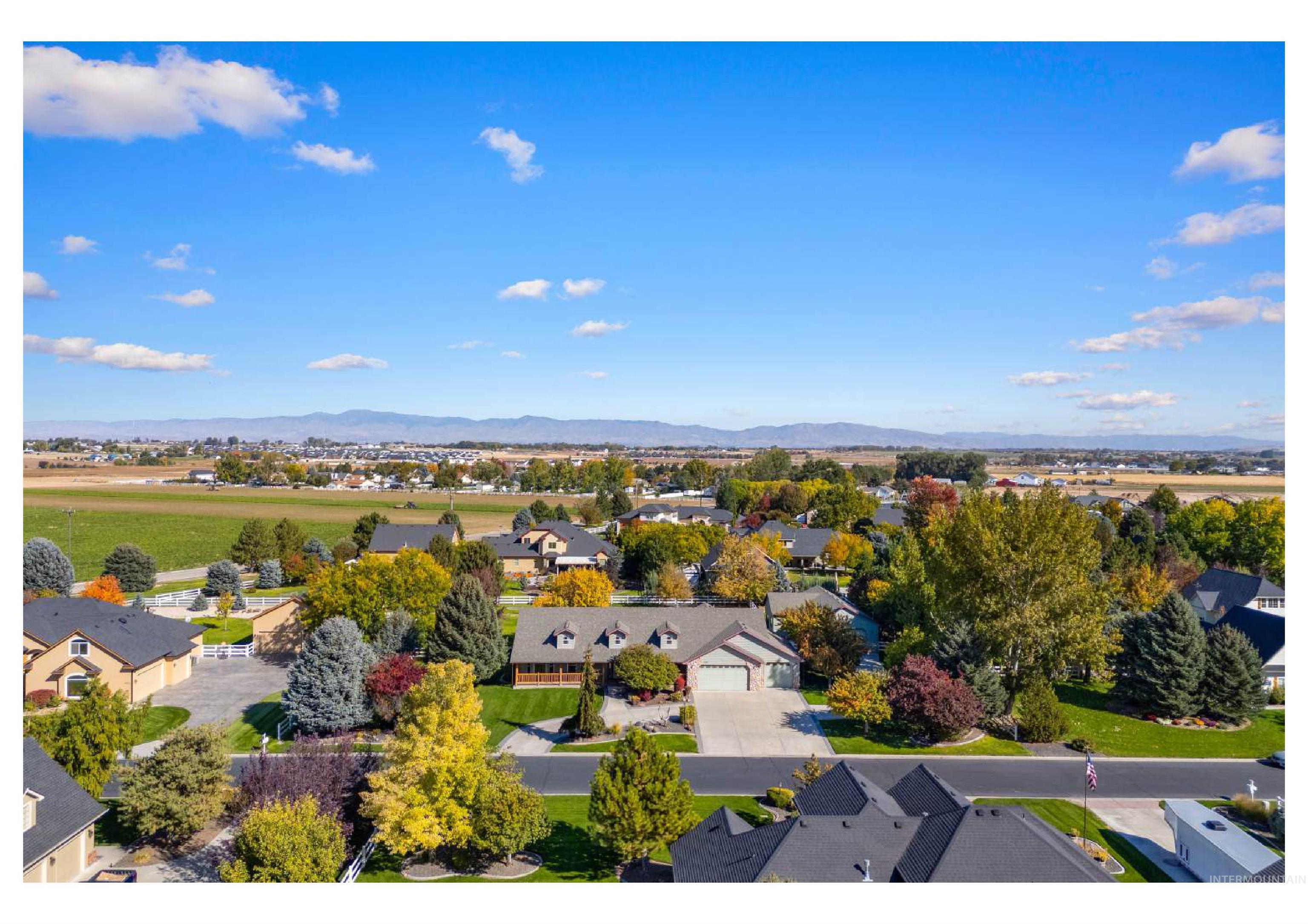 Aerial perspective of suburban area featuring a mountainous background