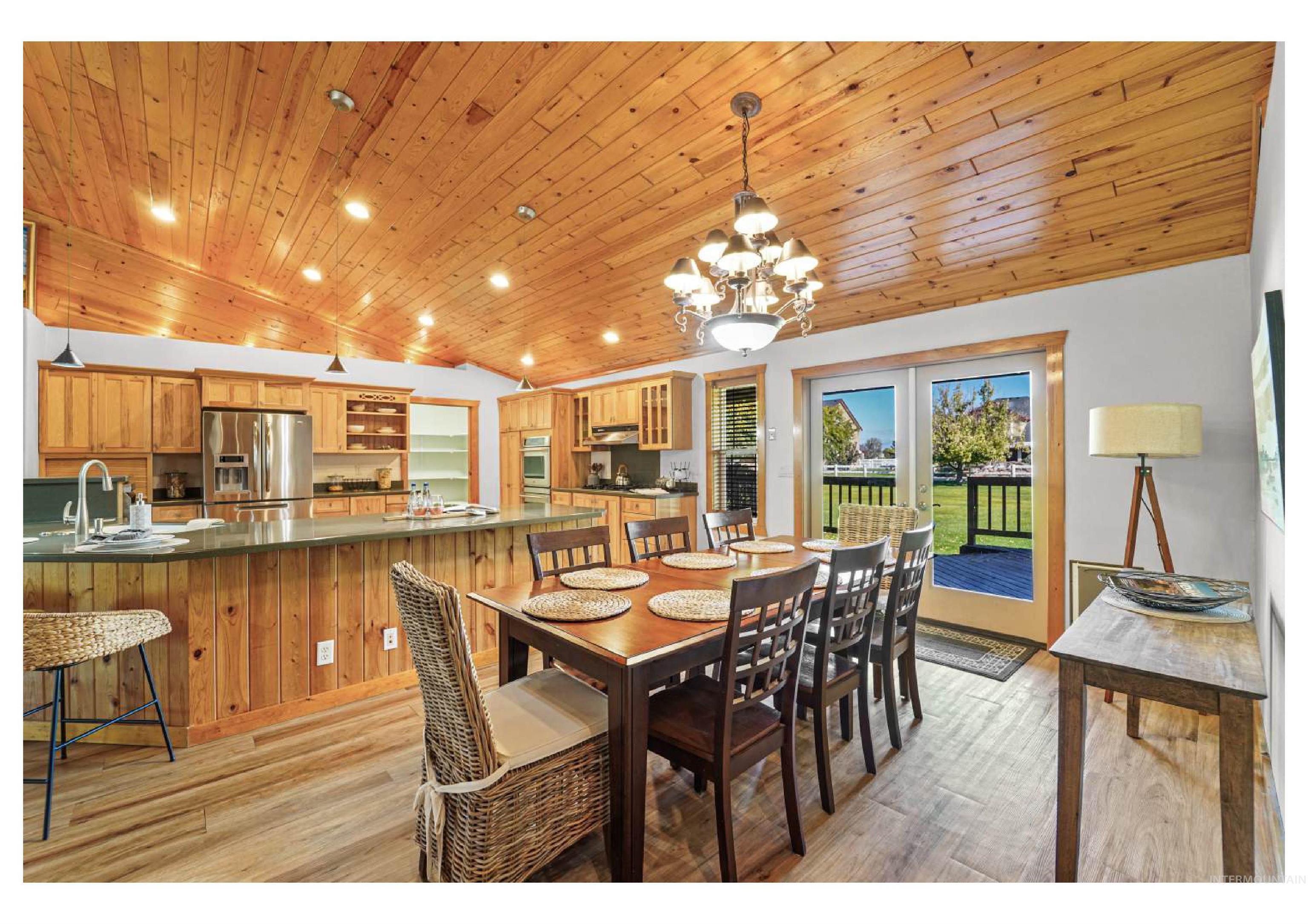 Dining space with vaulted ceiling, light wood-style flooring, recessed lighting, wooden ceiling, and a chandelier