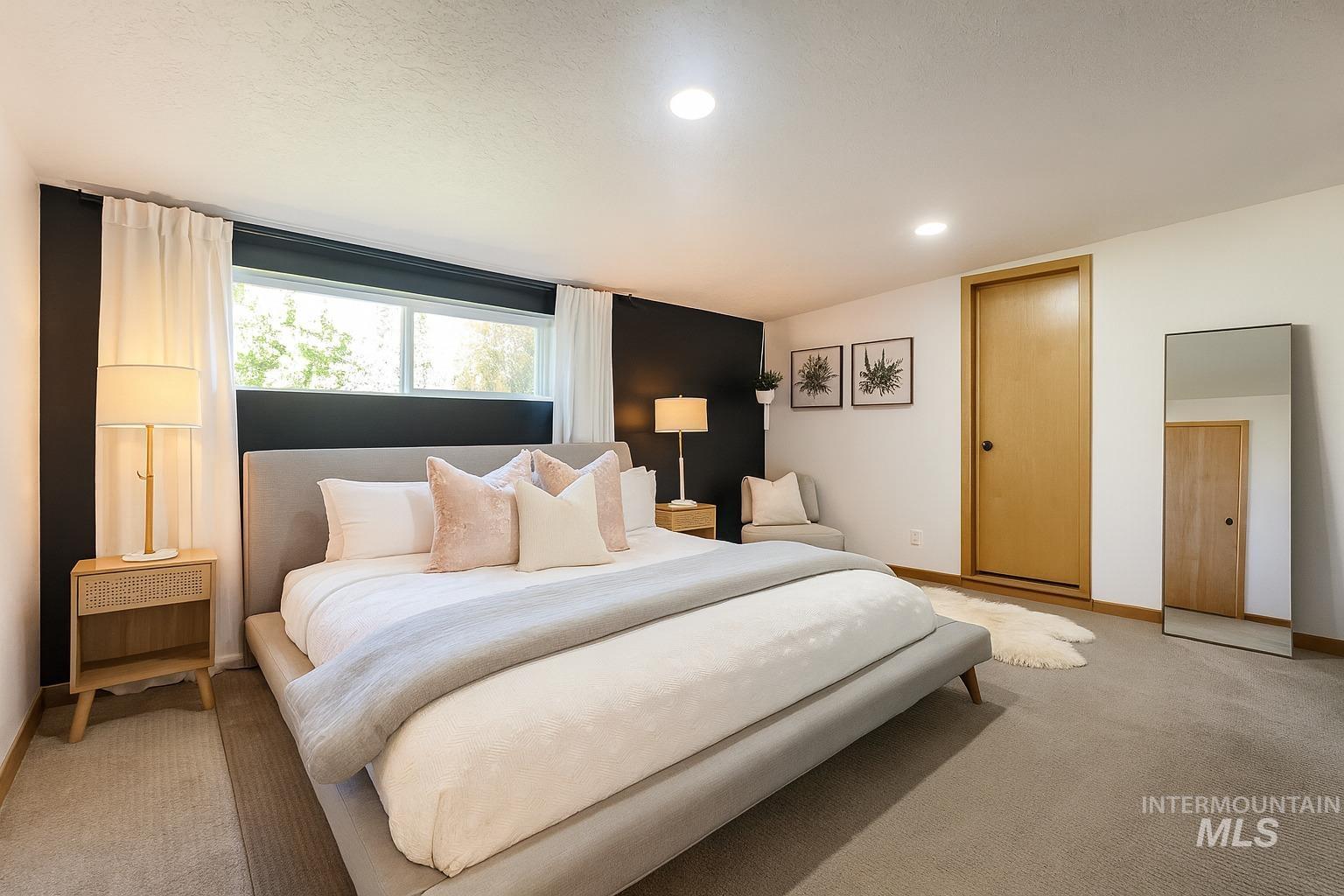 Bedroom with carpet flooring, recessed lighting, and a textured ceiling