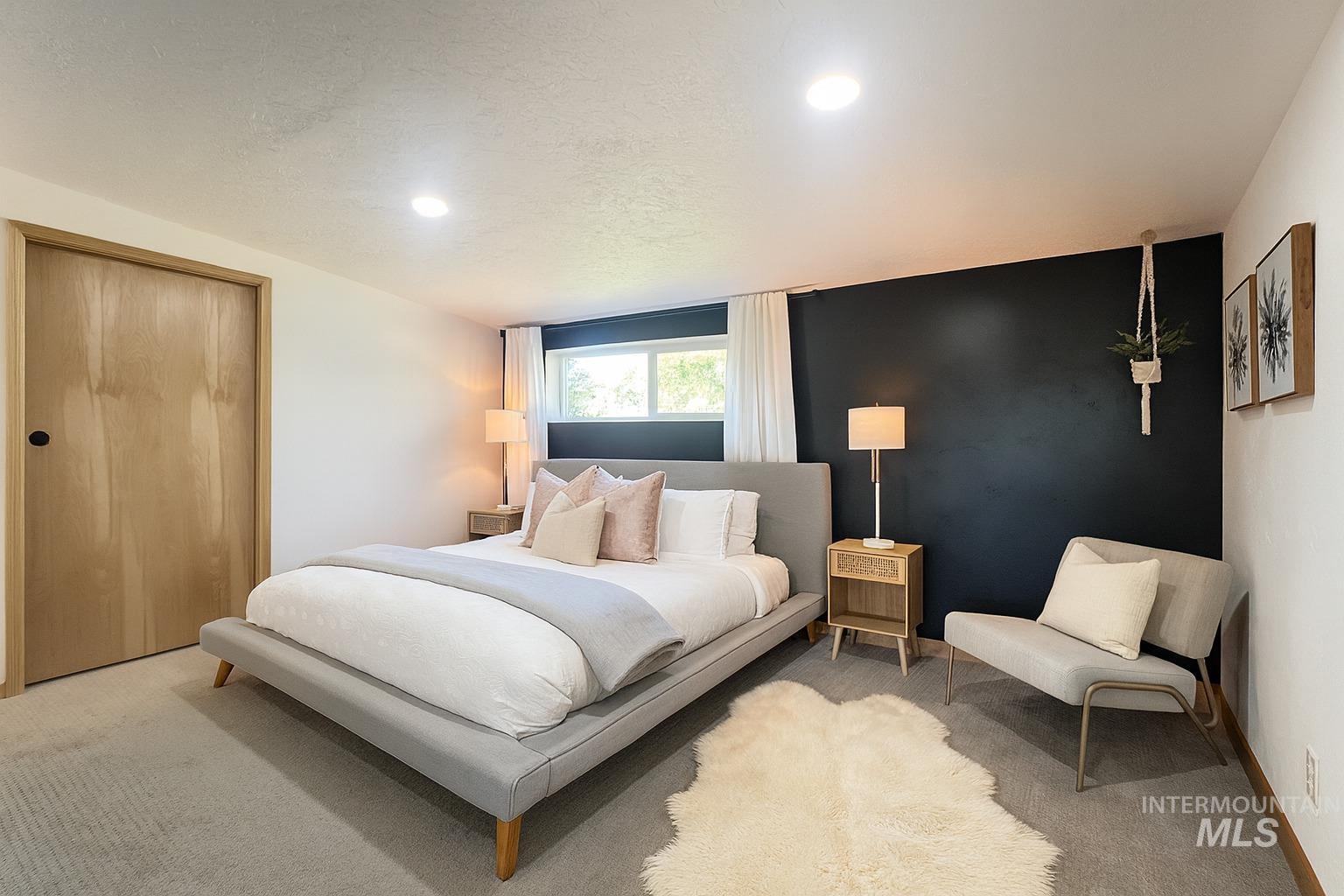 Bedroom with carpet, a closet, a textured ceiling, and recessed lighting
