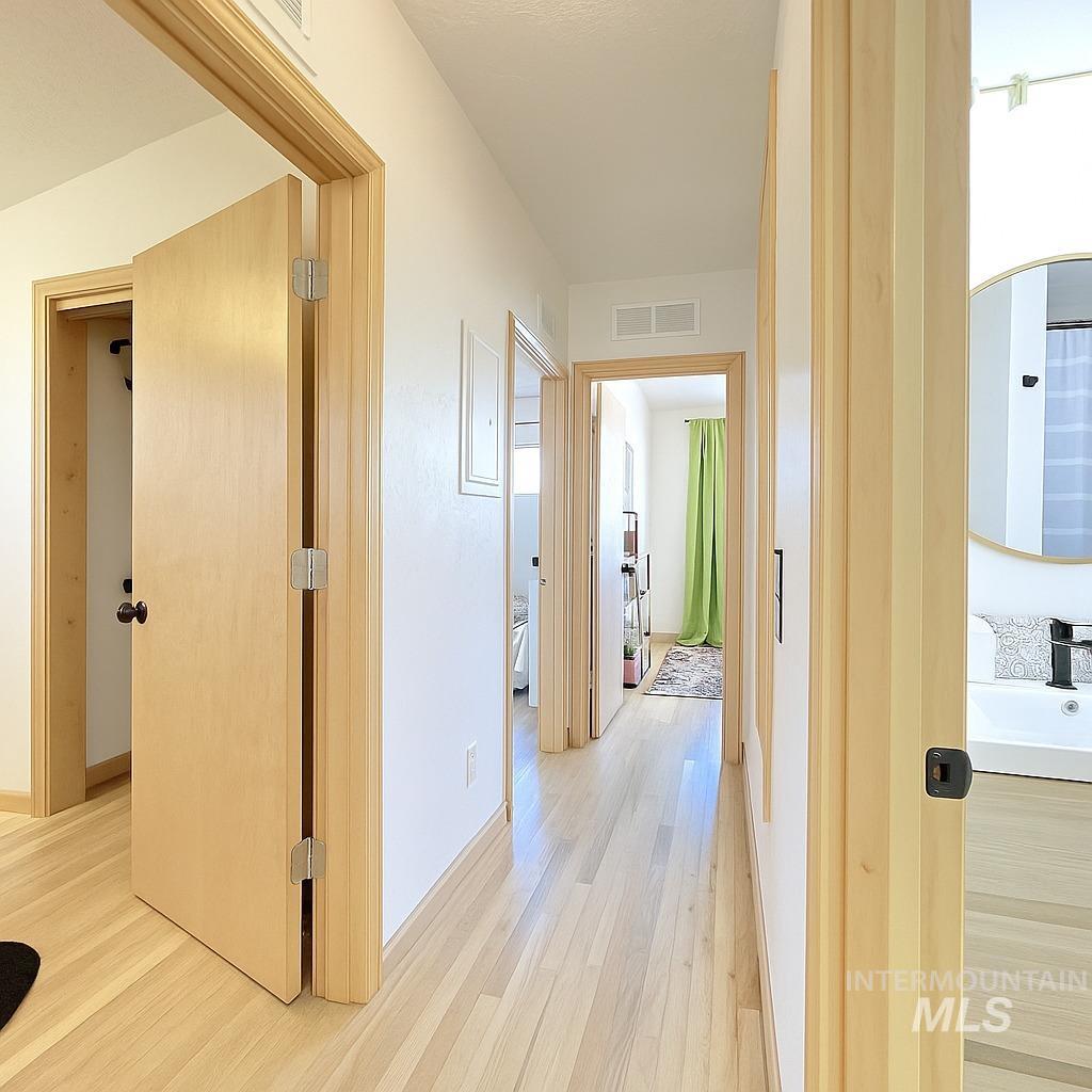 Hall with light wood finished floors and a sink