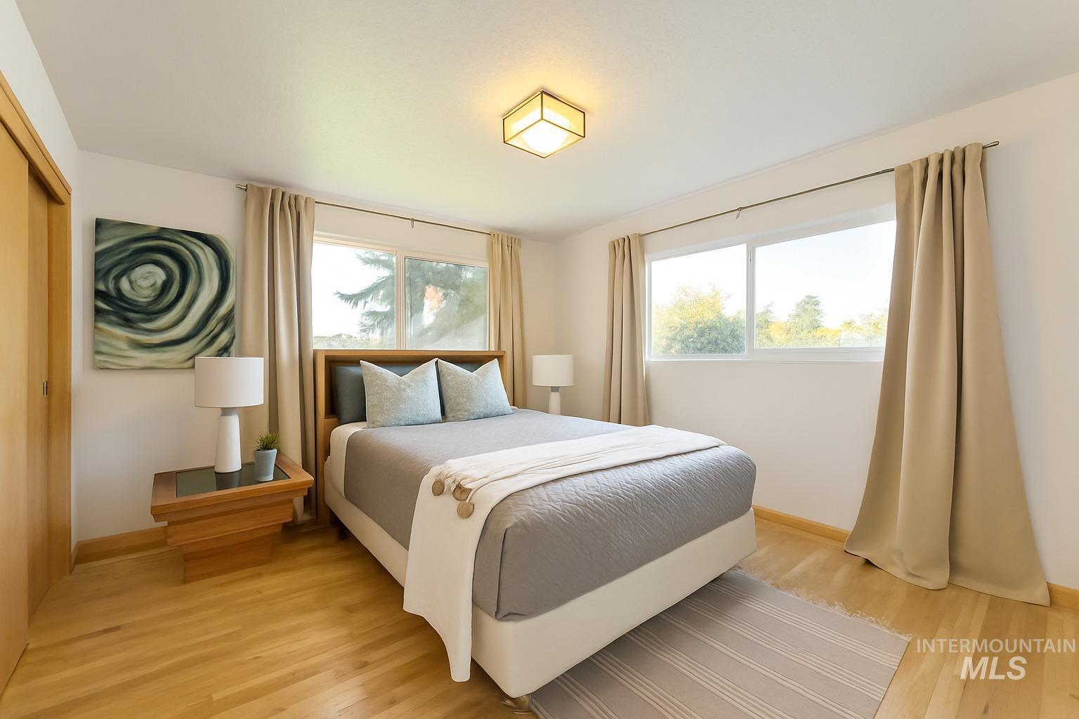 Bedroom with light wood-type flooring and a closet