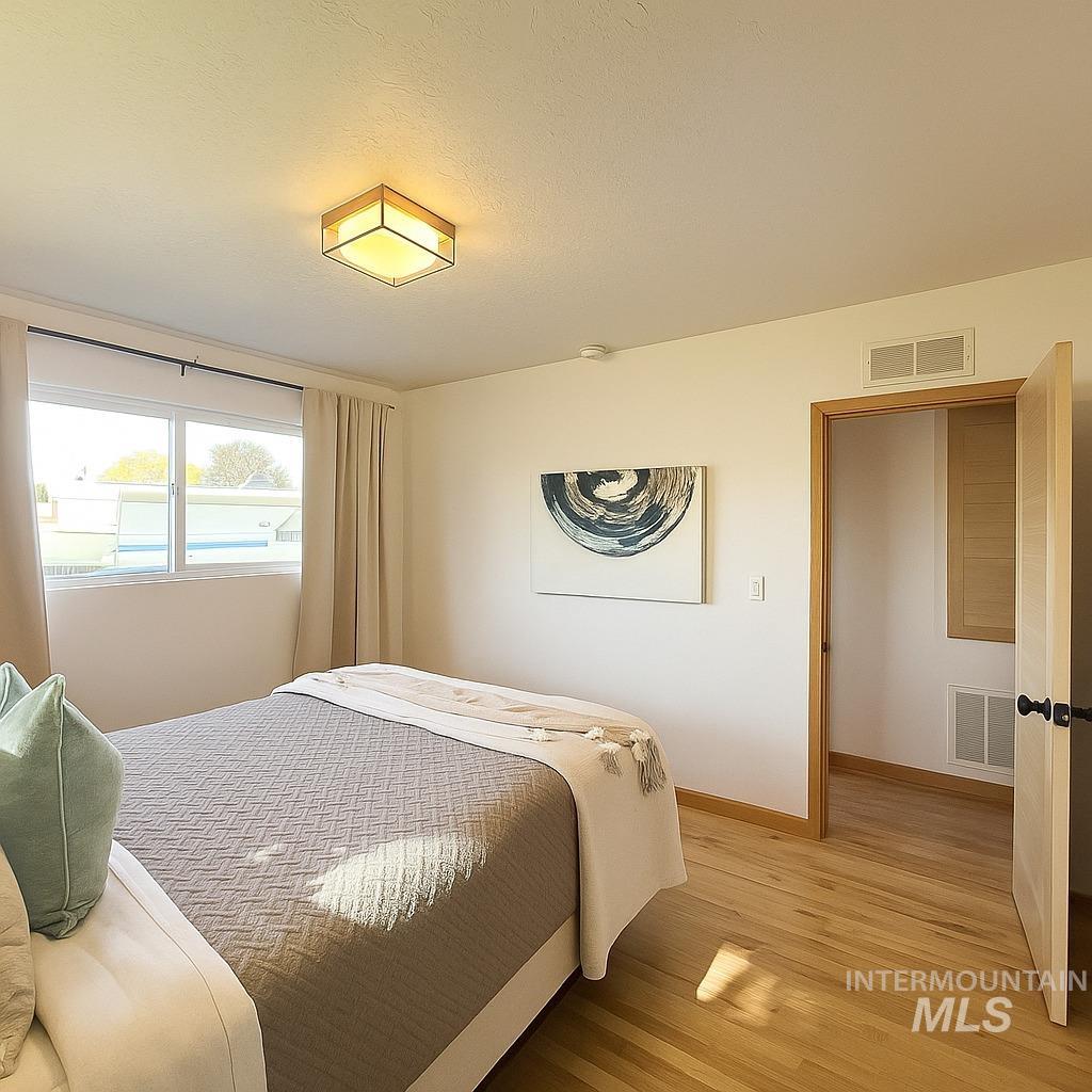 Bedroom featuring baseboards and light wood-style flooring