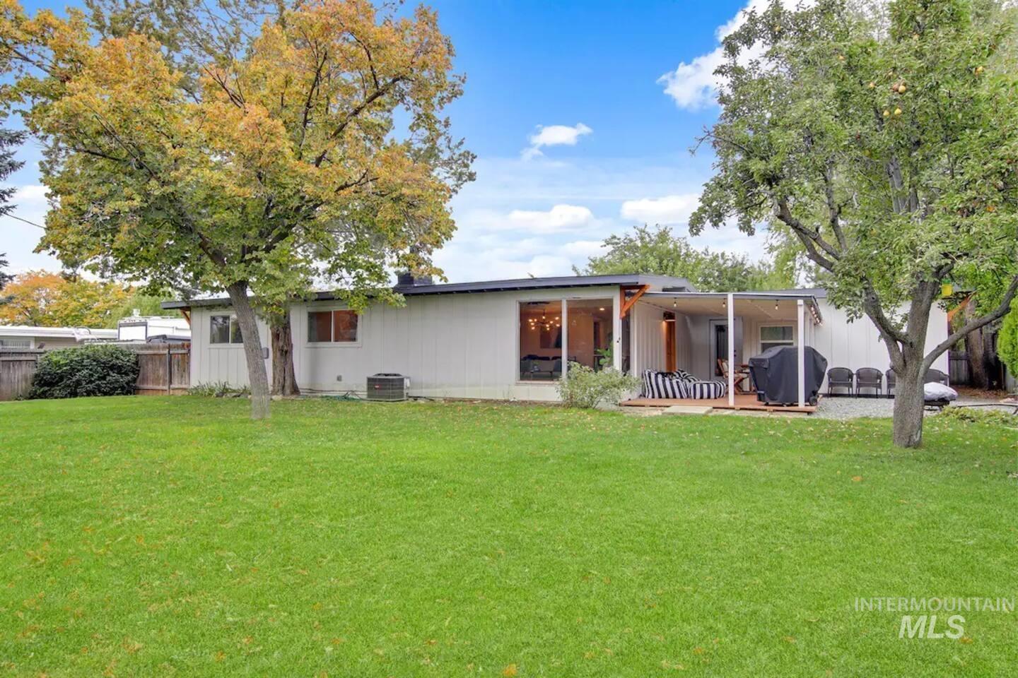 Rear view of property featuring a patio and a carport