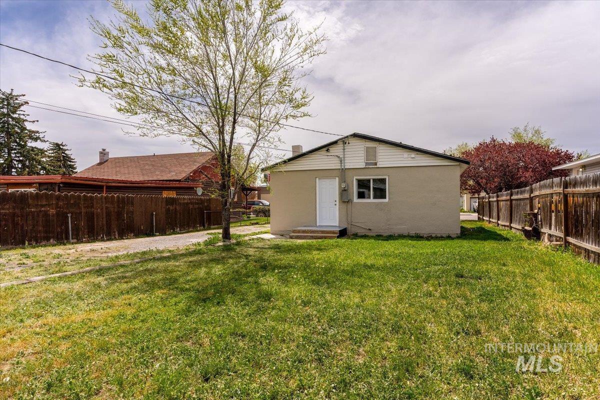 Rear view of property featuring a fenced backyard