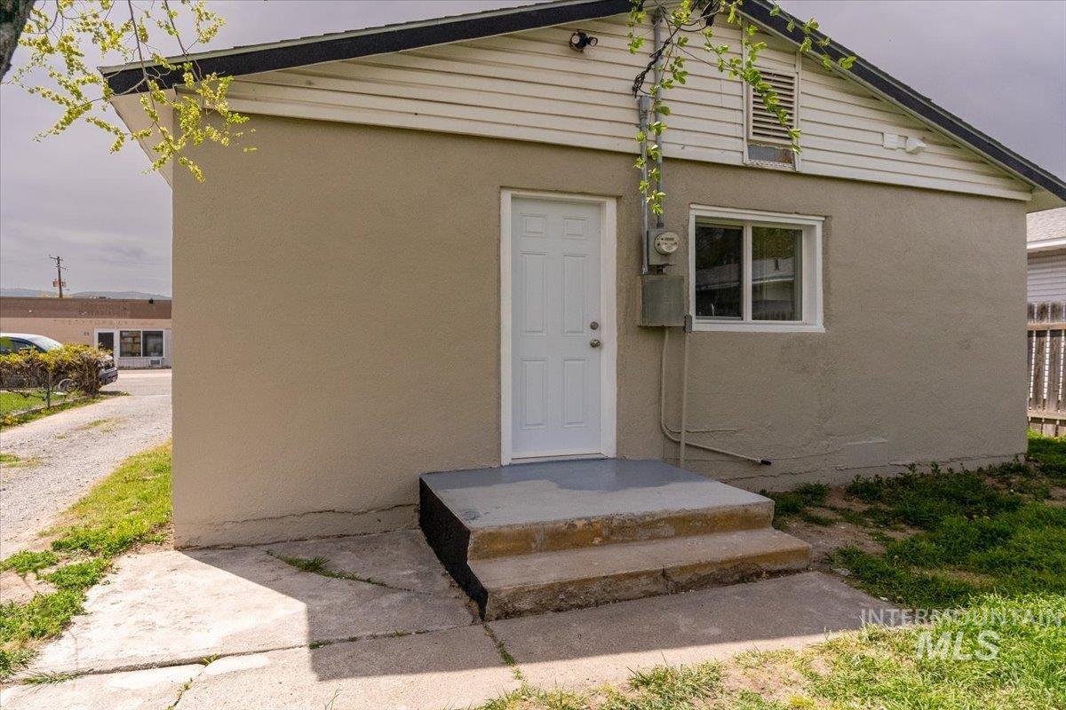 Property entrance with stucco siding