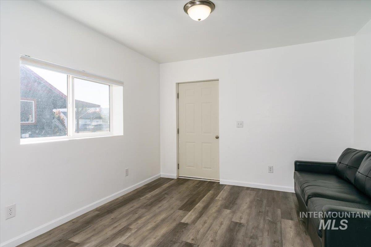 Unfurnished room with dark wood-style floors