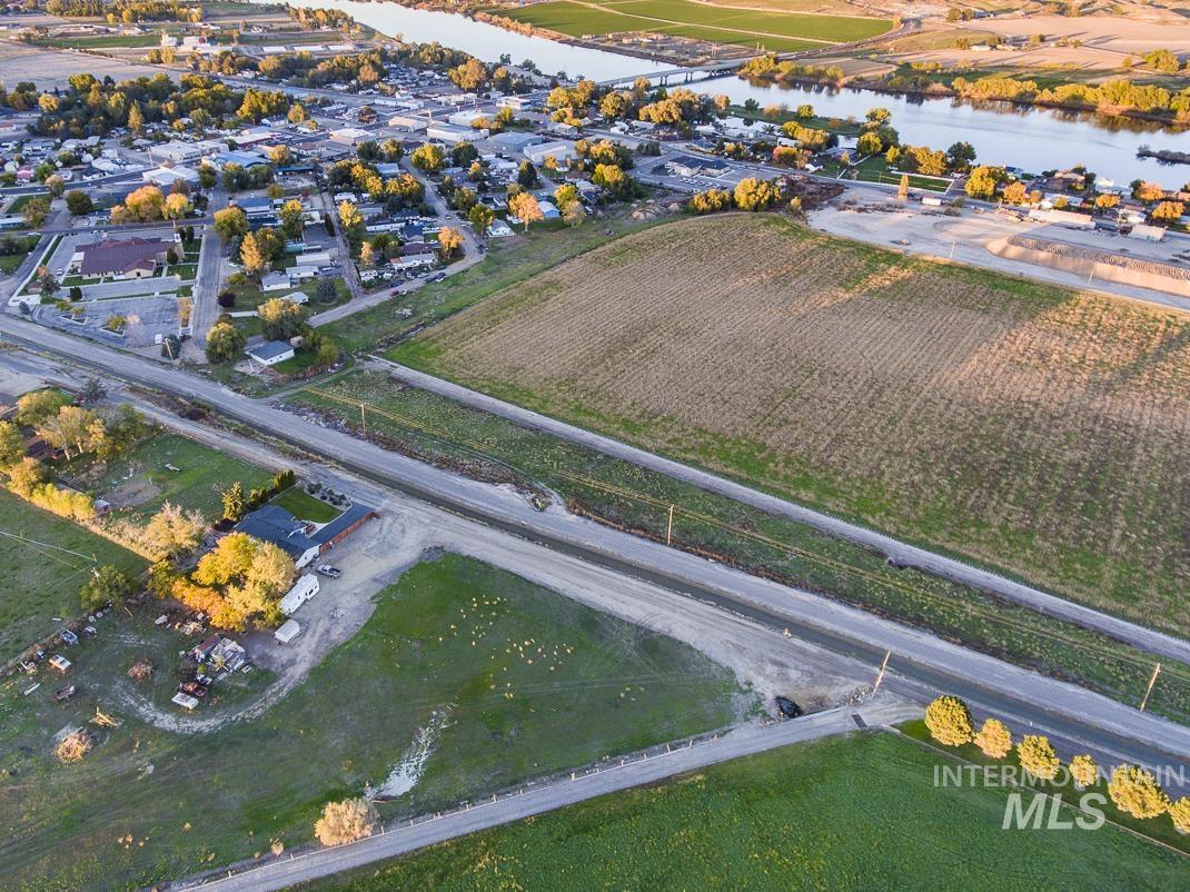 Aerial view of property's location with a nearby body of water and abundant farmland