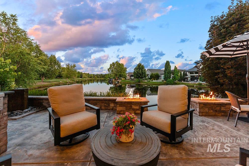 View of patio / terrace with a fire pit and a water view