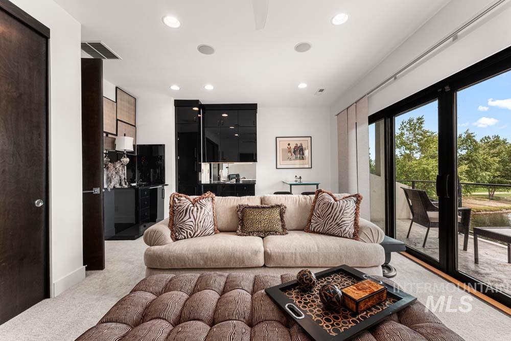 Living area featuring light carpet, recessed lighting, and billiards table
