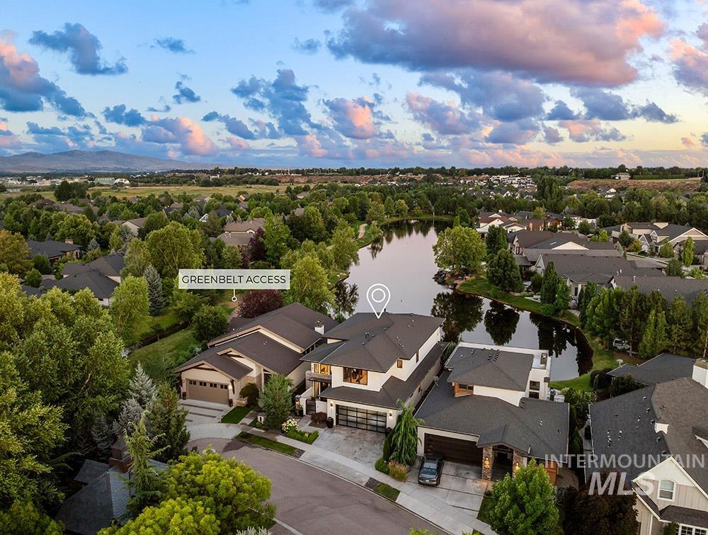 Aerial view at dusk of a water view and a residential view