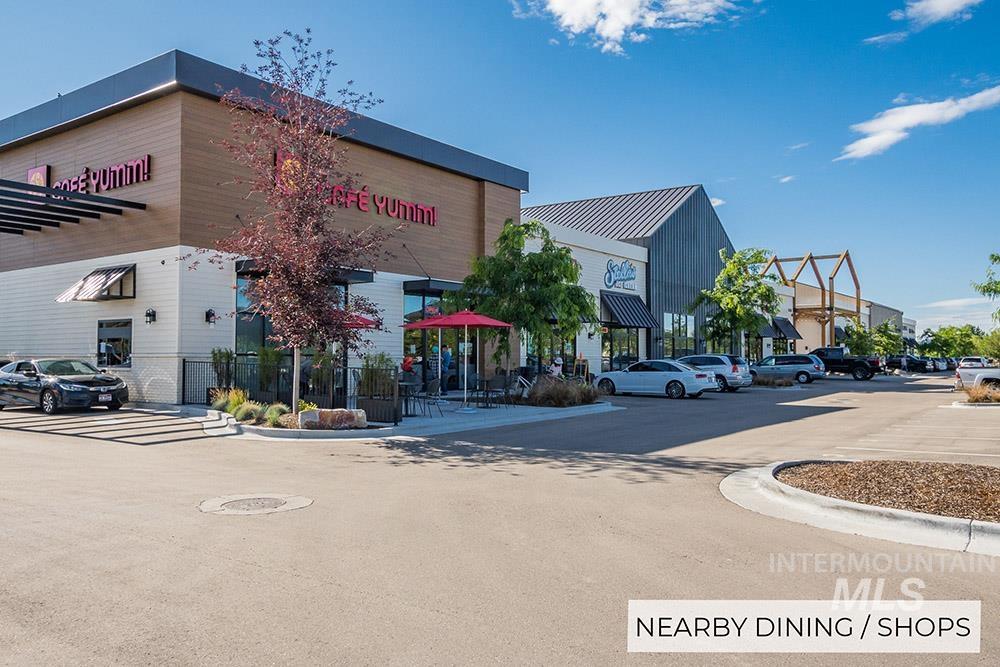 View of property featuring uncovered parking