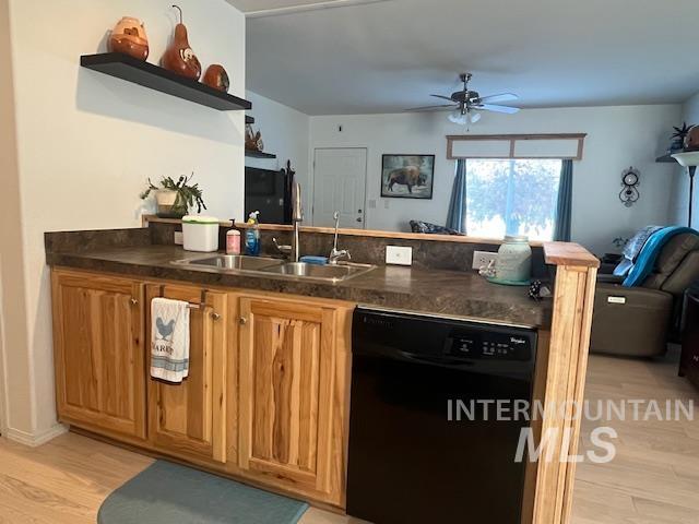 Kitchen with open floor plan, light wood-type flooring, black dishwasher, dark countertops, and brown cabinets