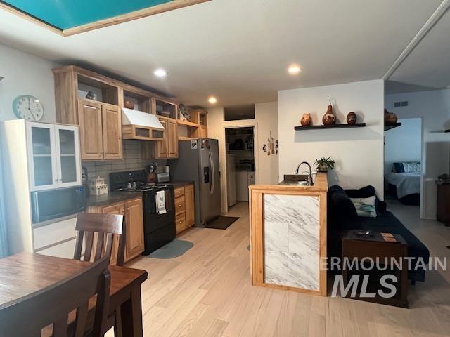 Kitchen with open shelves, black range with electric cooktop, custom range hood, dark countertops, and recessed lighting