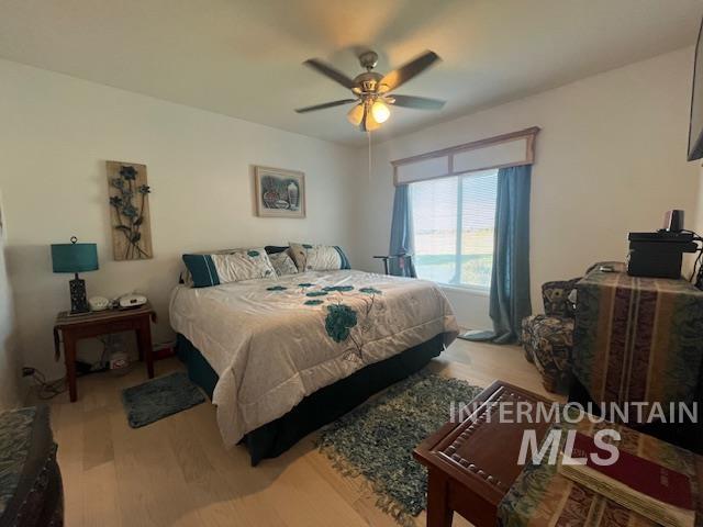 Bedroom featuring light wood-style floors and a ceiling fan