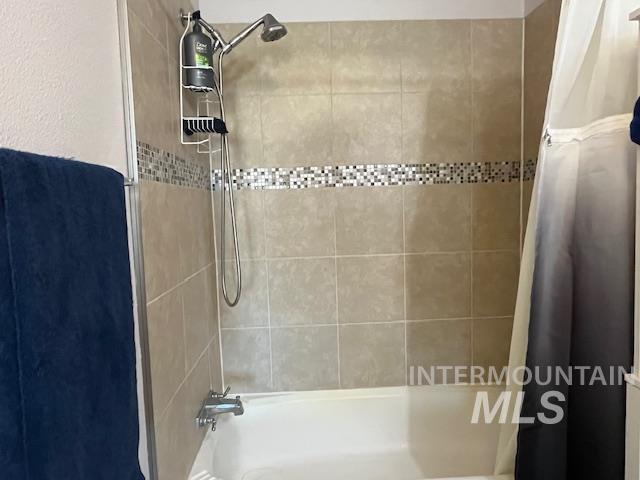 Full bath with shower / bath combination with curtain