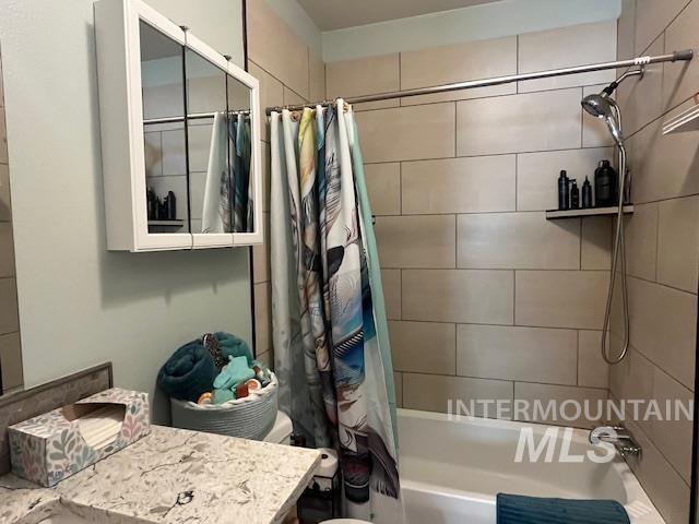 Full bathroom with vanity and shower / bath combo with shower curtain