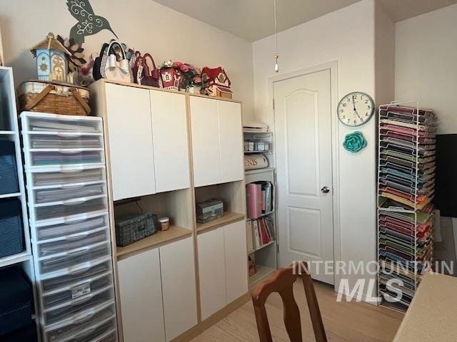 Home office with light wood finished floors