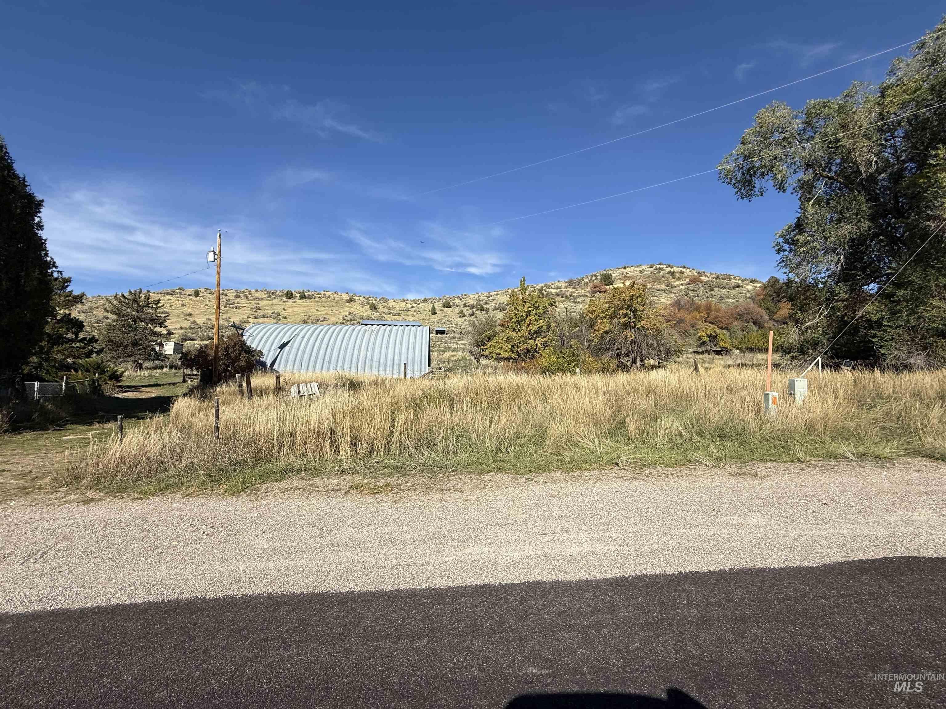 View of asphalt street with a mountain view and a rural view