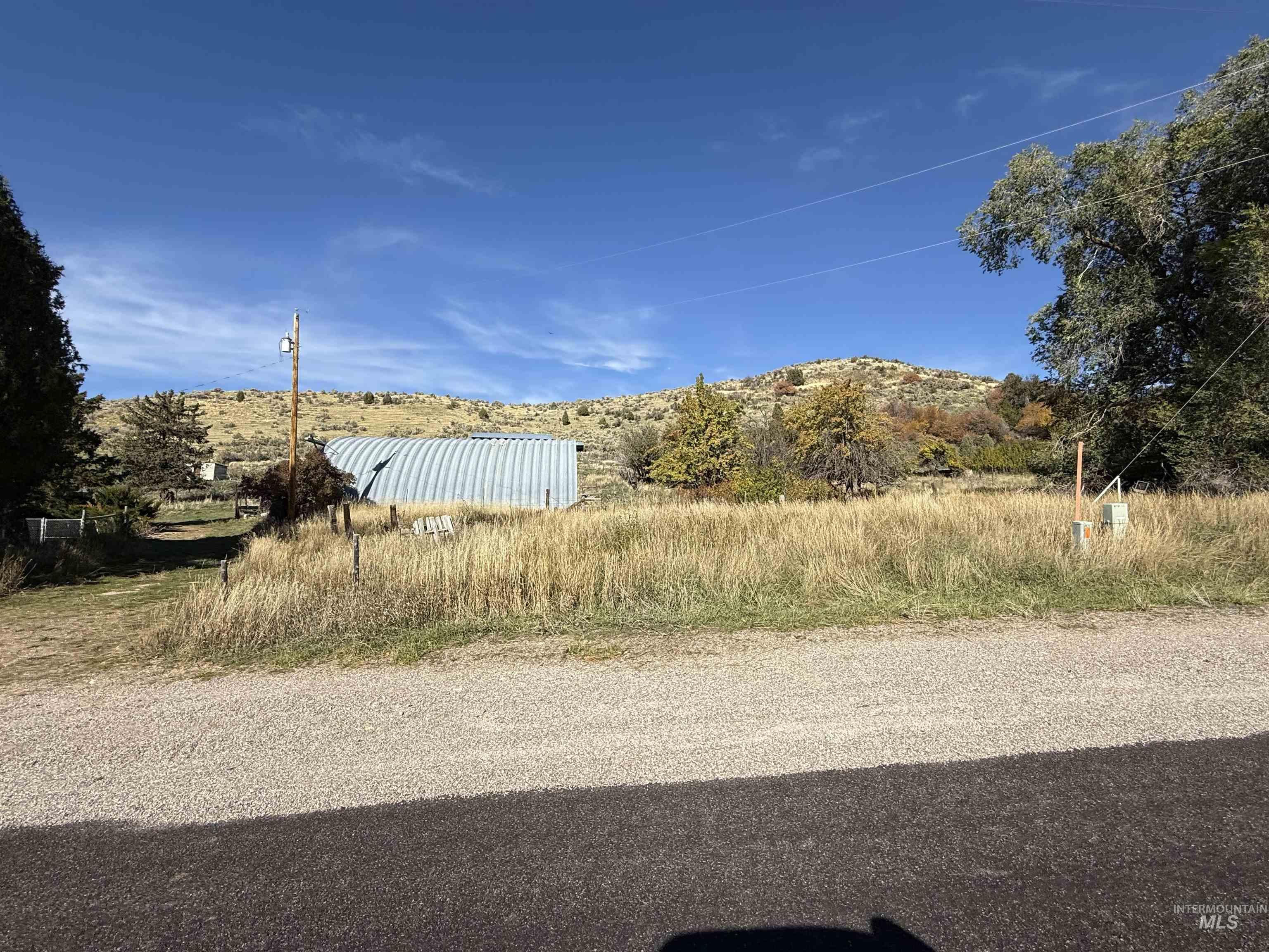 View of asphalt road with a mountain view and a view of rural / pastoral area