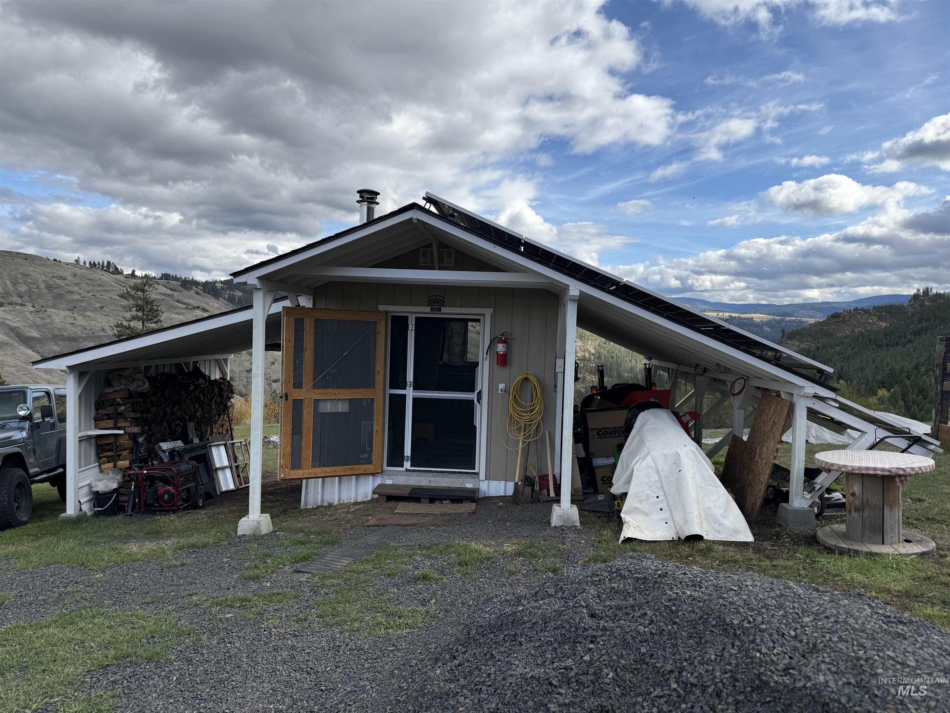 Front view of building w/solar batteries and panel.  Used for workshop also!