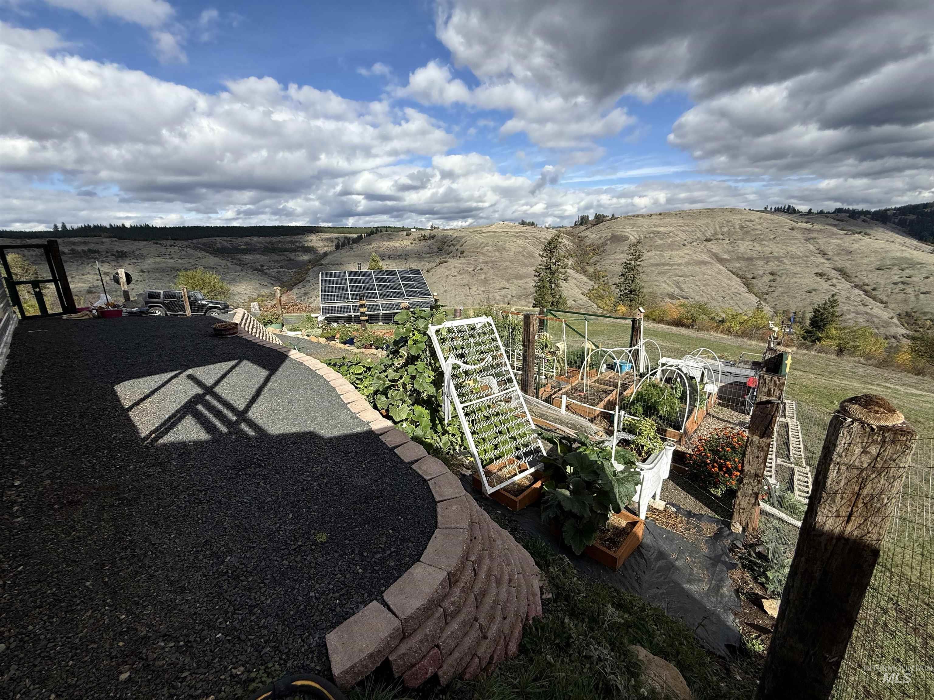 View of yard with a vegetable garden and a patio area