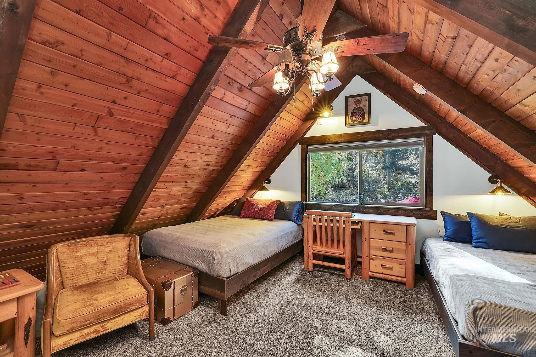 Bedroom featuring wooden ceiling, carpet flooring, and ceiling fan