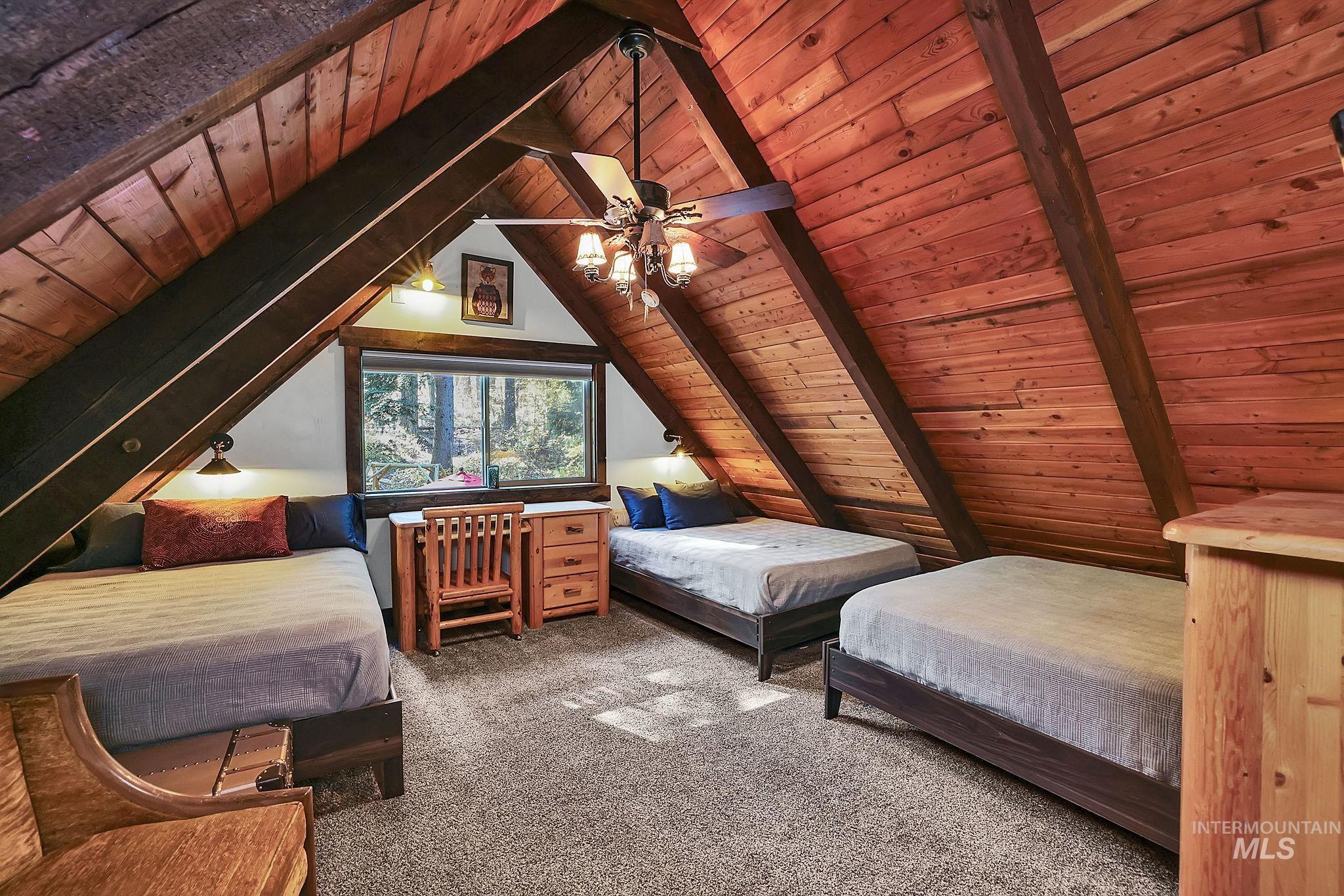 Bedroom with wood ceiling, carpet flooring, and a ceiling fan