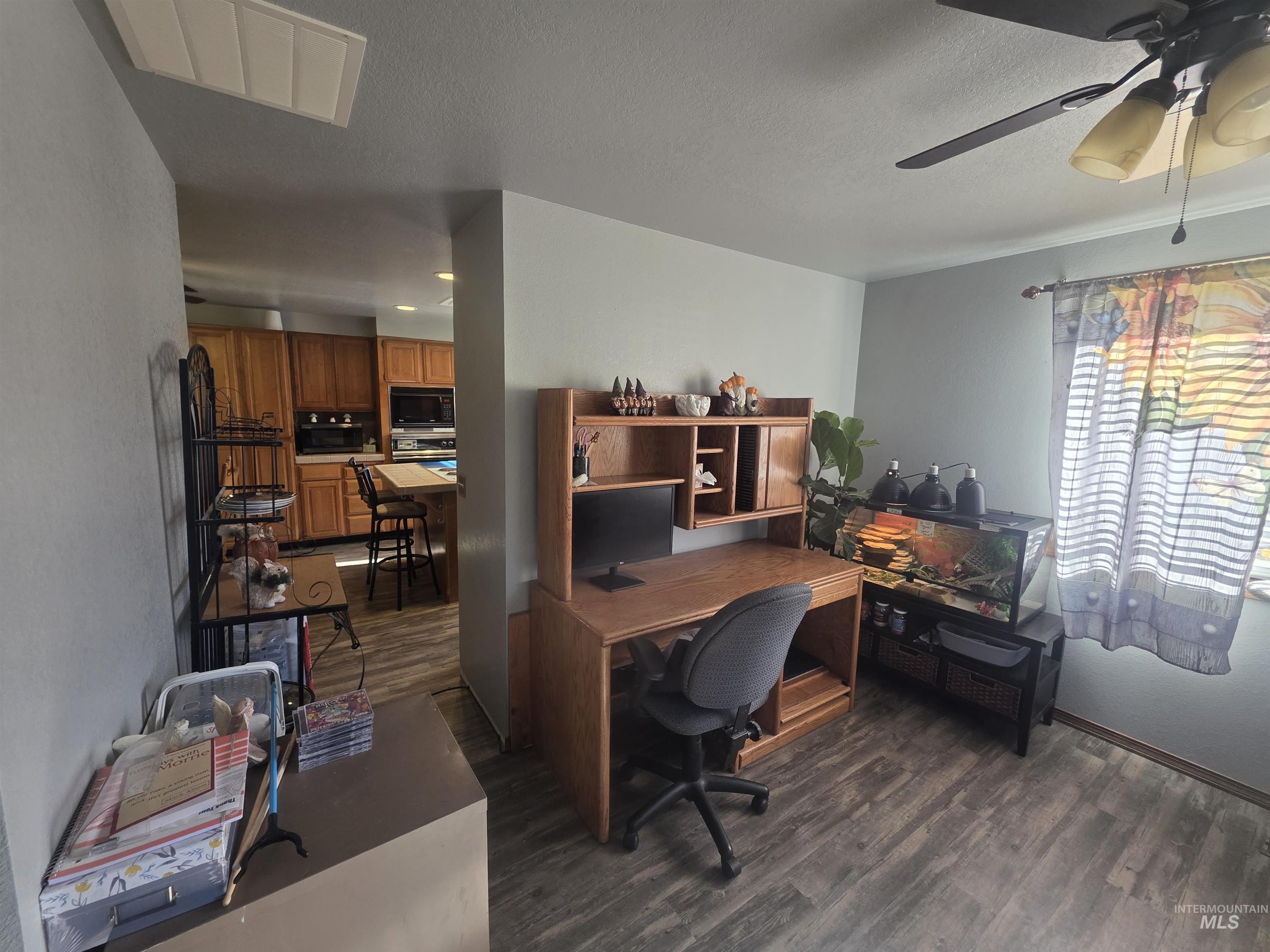 This formal dining room is connected to the living room and accessible from kitchen. This photo shows the view into the kitchen.