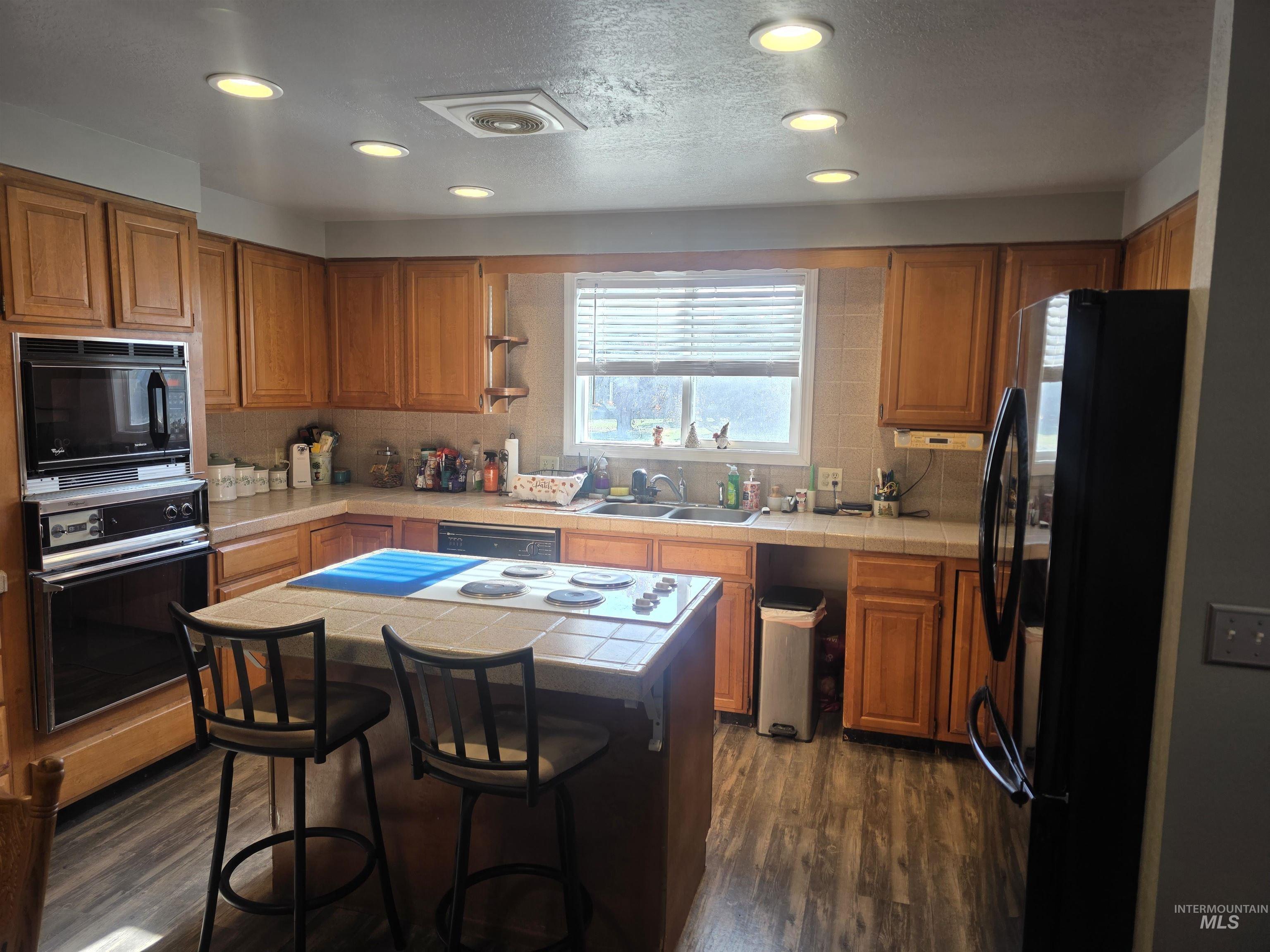 Main kitchen with island/breakfast bar and stove