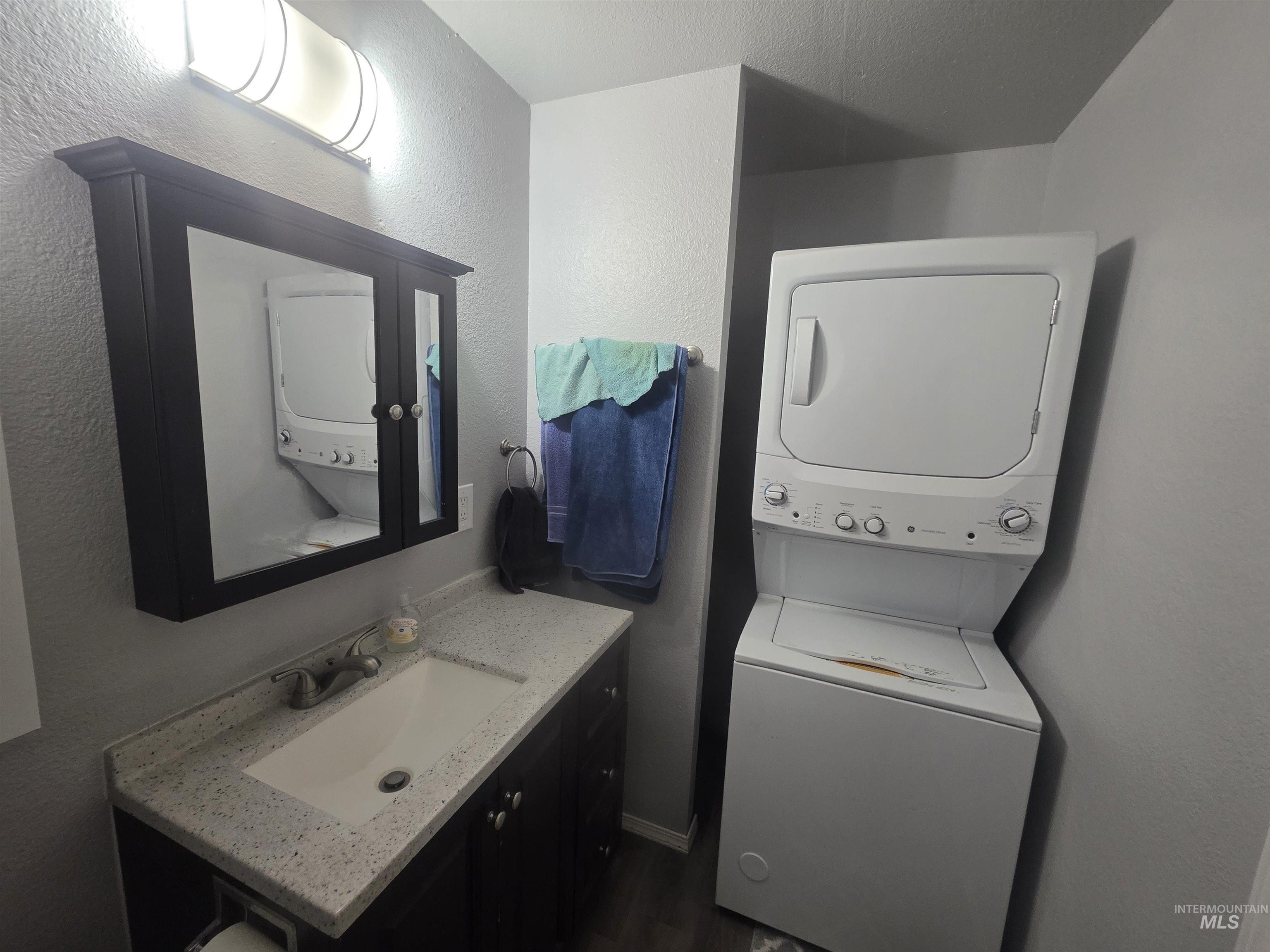 Bathroom for the duplex suite with stackable washer/dryer.