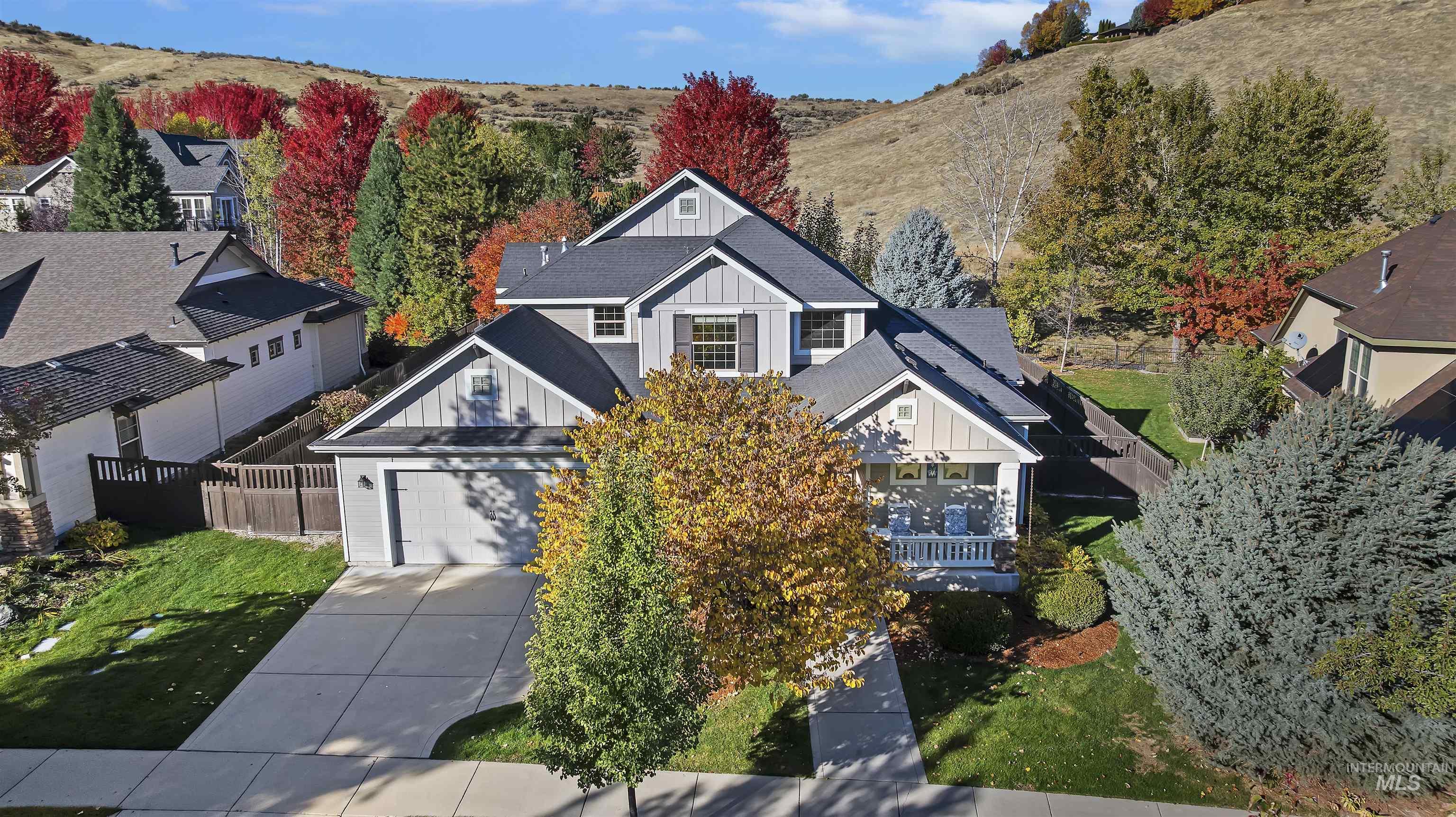 View of front of house featuring board and batten siding, concrete driveway, and a garage