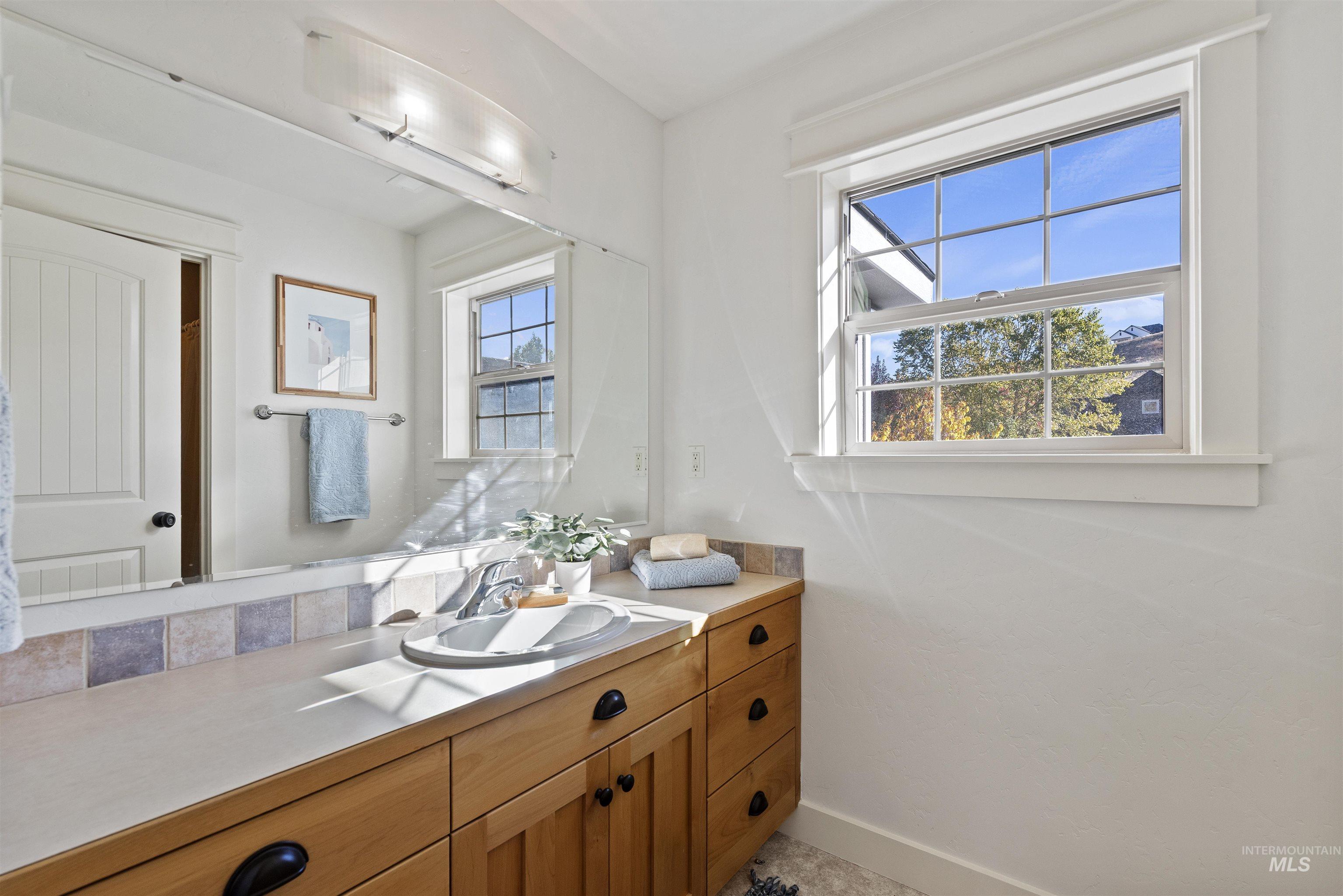 Bathroom with vanity and baseboards