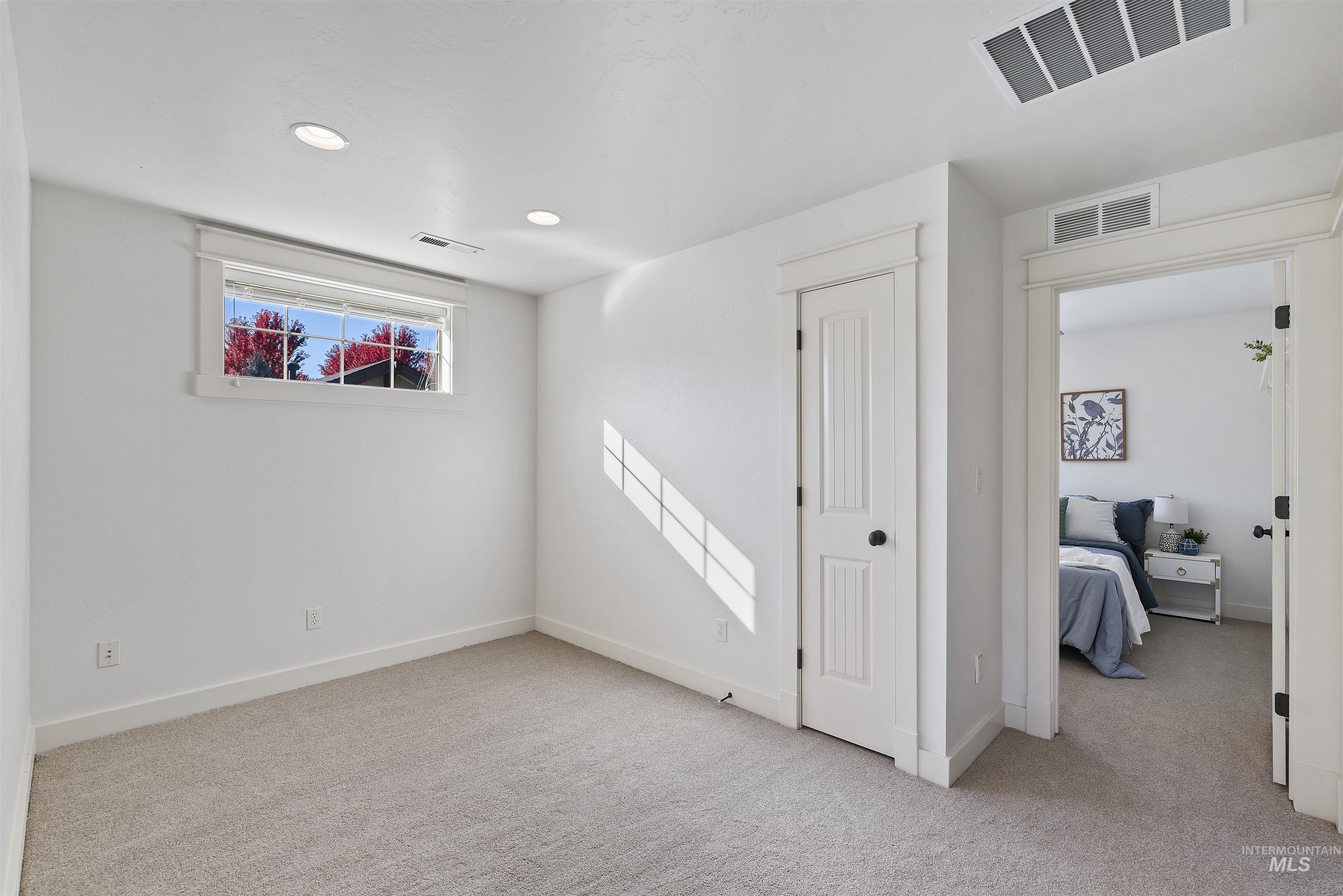 Spare room with light carpet and recessed lighting