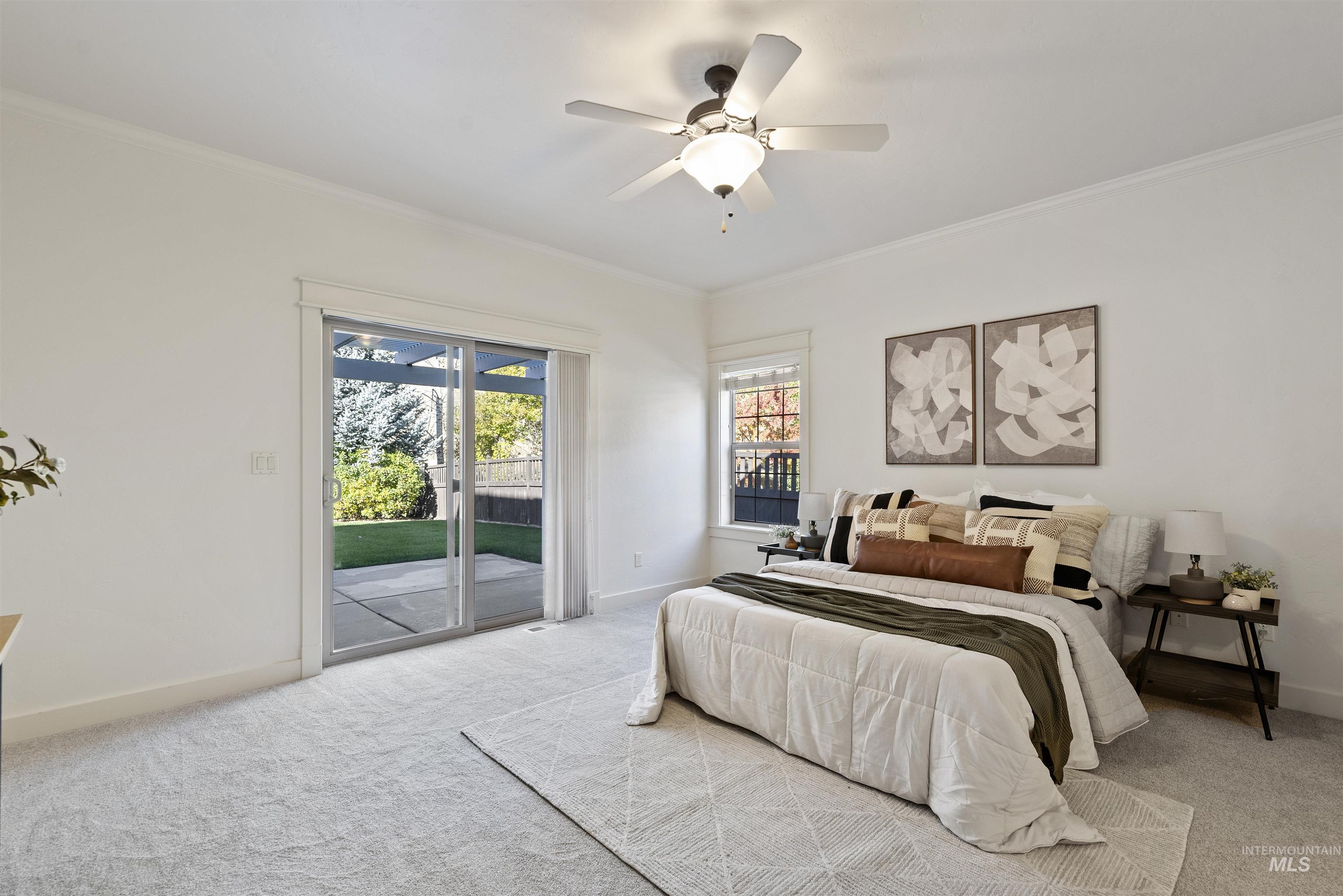Carpeted bedroom with ornamental molding, access to outside, and a ceiling fan
