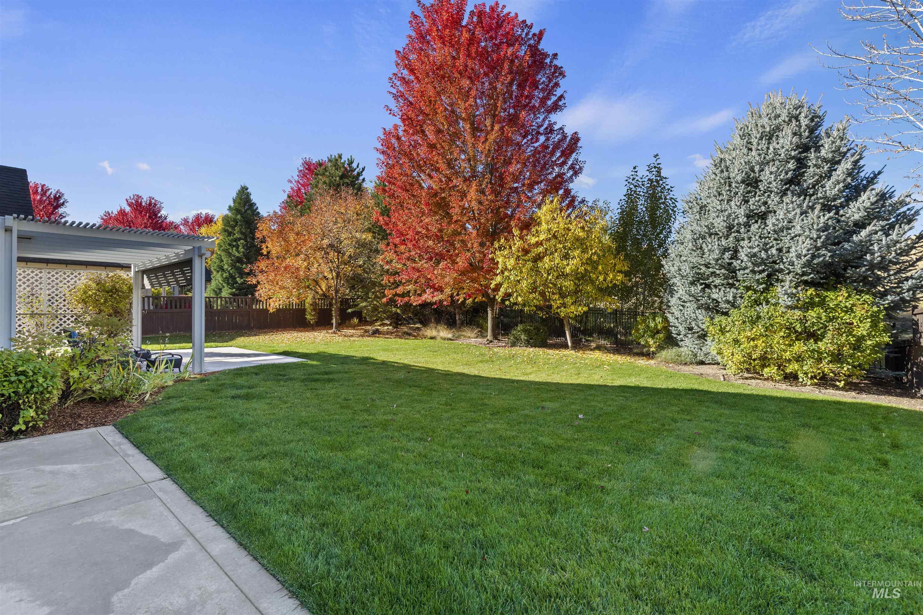 Fenced backyard featuring a pergola and a patio area