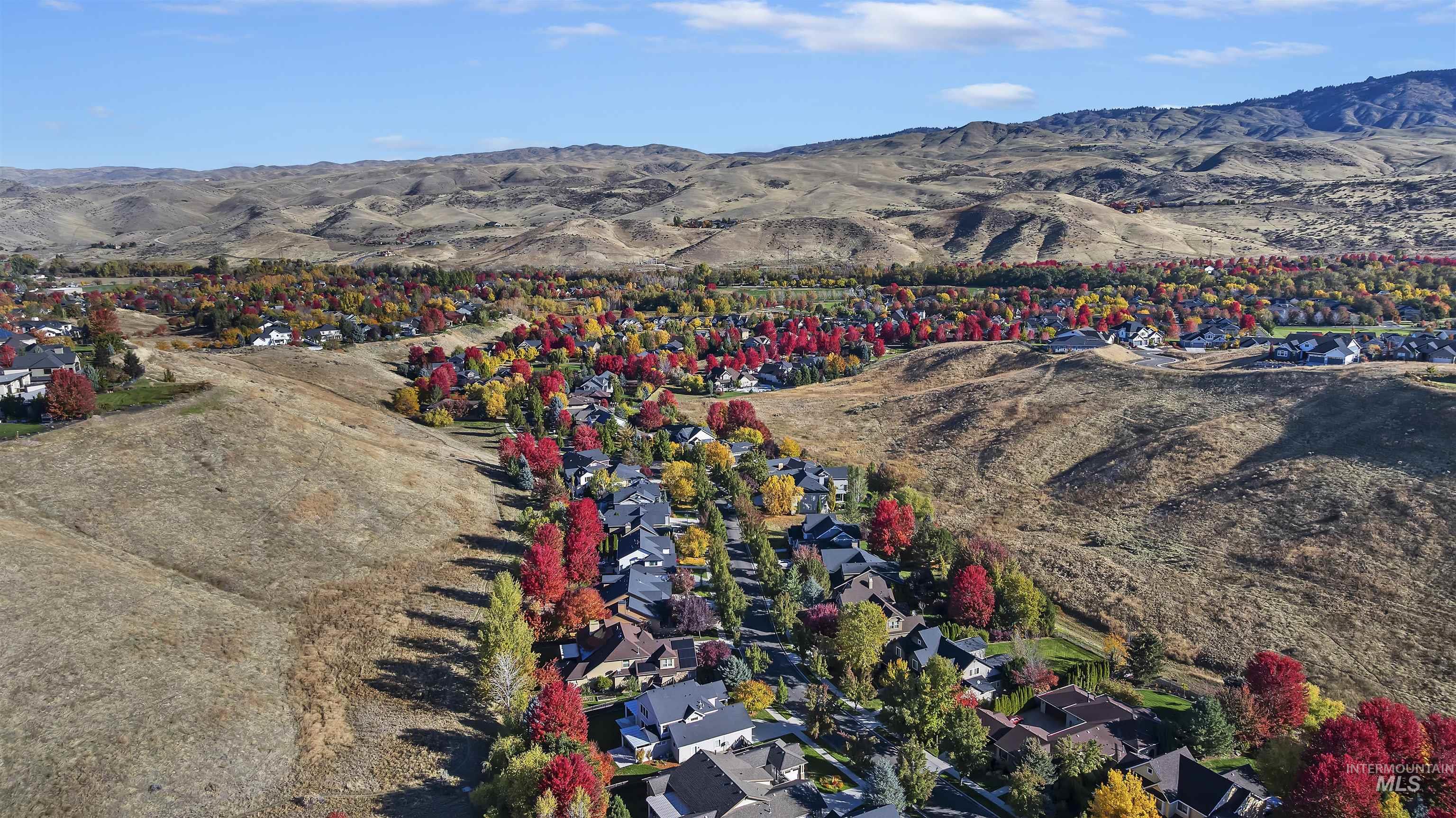 Aerial overview of property's location with mountains and nearby suburban area