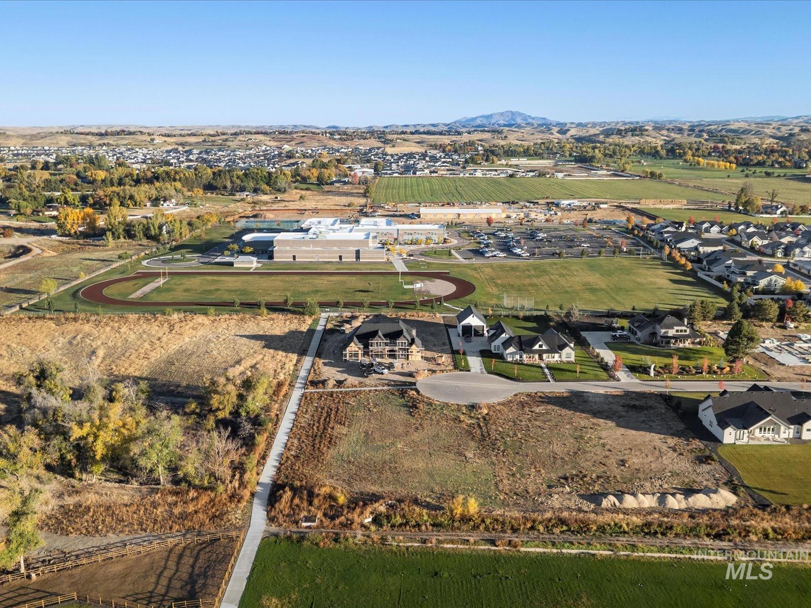 Aerial overview of property's location featuring nearby suburban area and a mountainous background