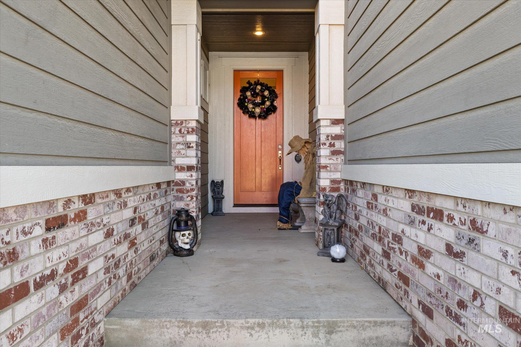 Entrance to property featuring brick siding