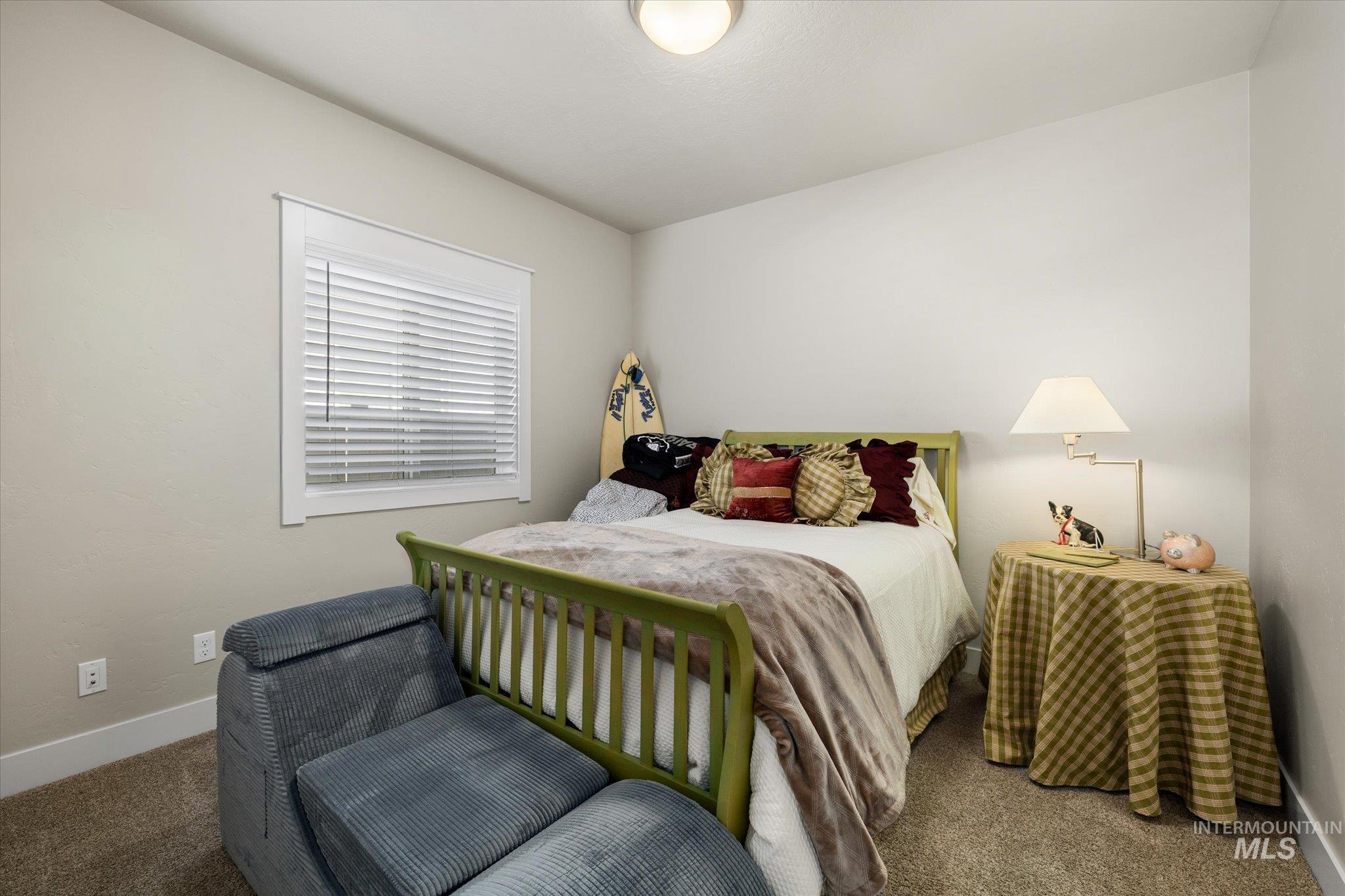 Carpeted bedroom featuring baseboards