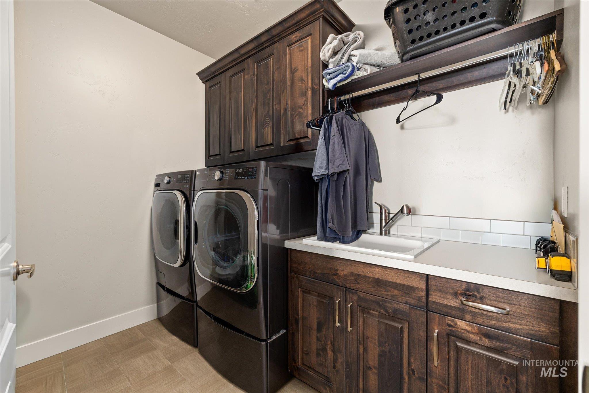 Washroom with cabinet space and independent washer and dryer