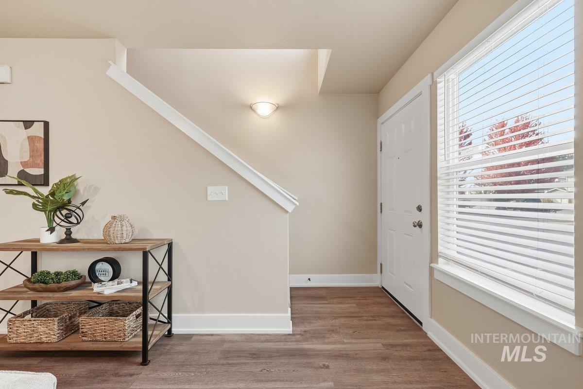 Entryway featuring baseboards and wood finished floors