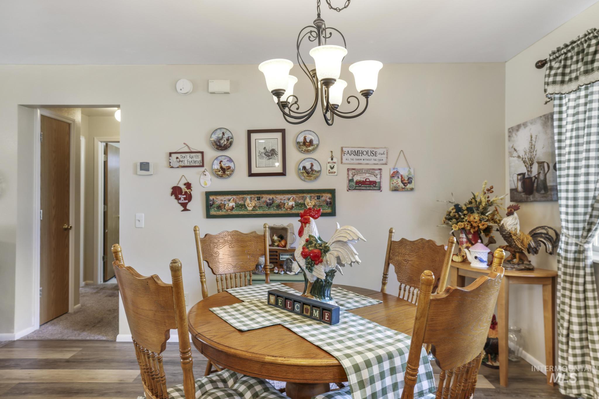 Dining room featuring wood finished floors and a chandelier