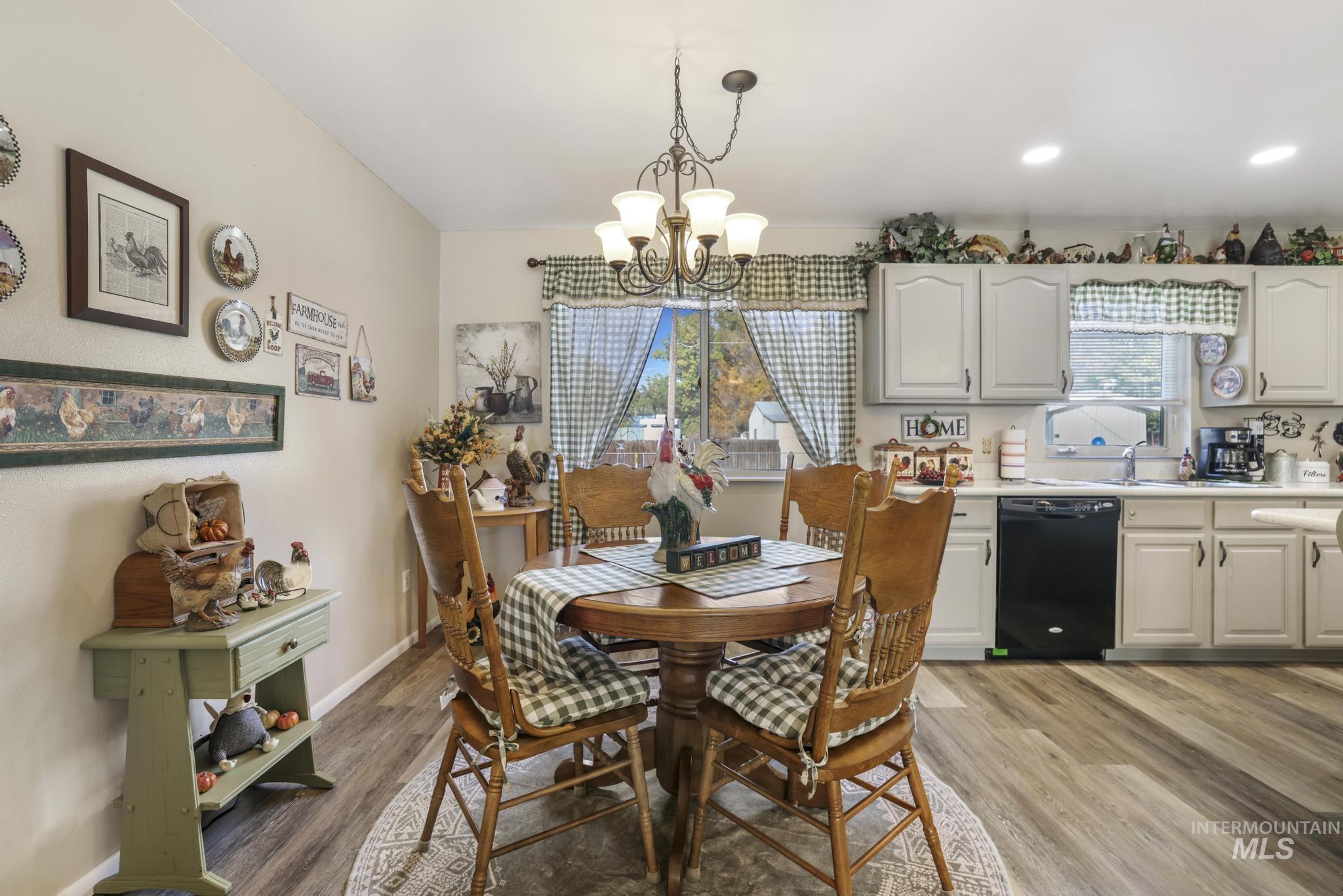 Dining space with light wood-style floors, a chandelier, and recessed lighting