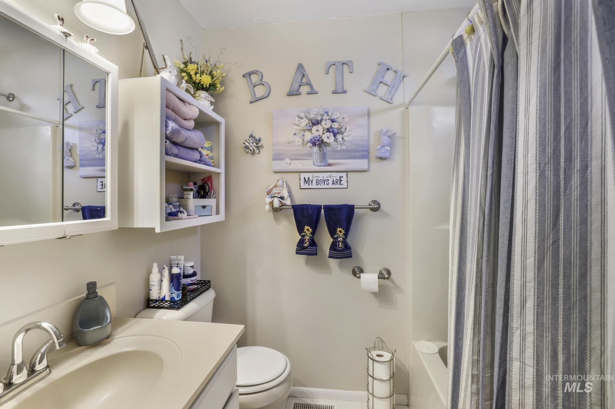 Bathroom with vanity and shower / bath combination with curtain