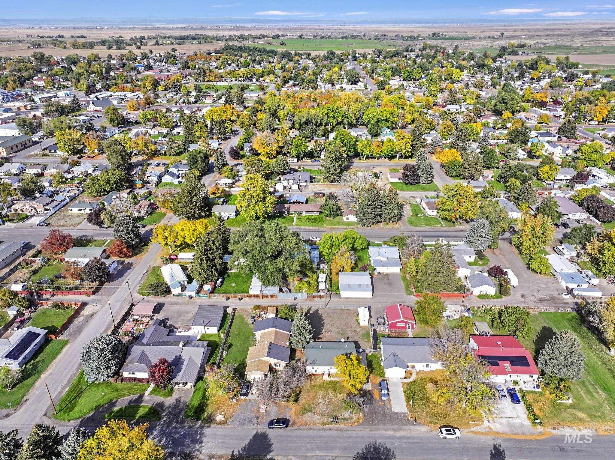 Aerial view of property and surrounding area with nearby suburban area