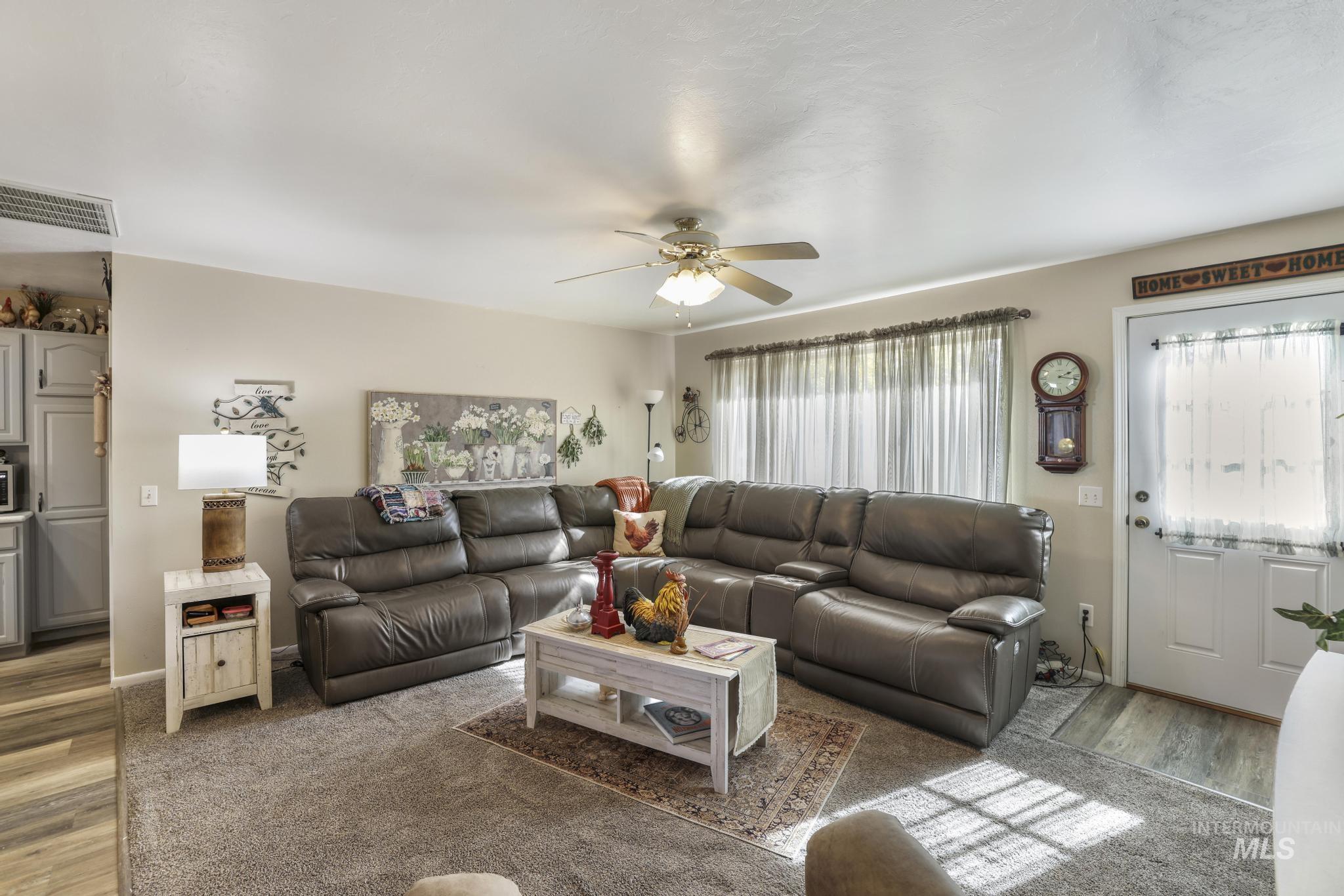 Living room with wood finished floors and a ceiling fan